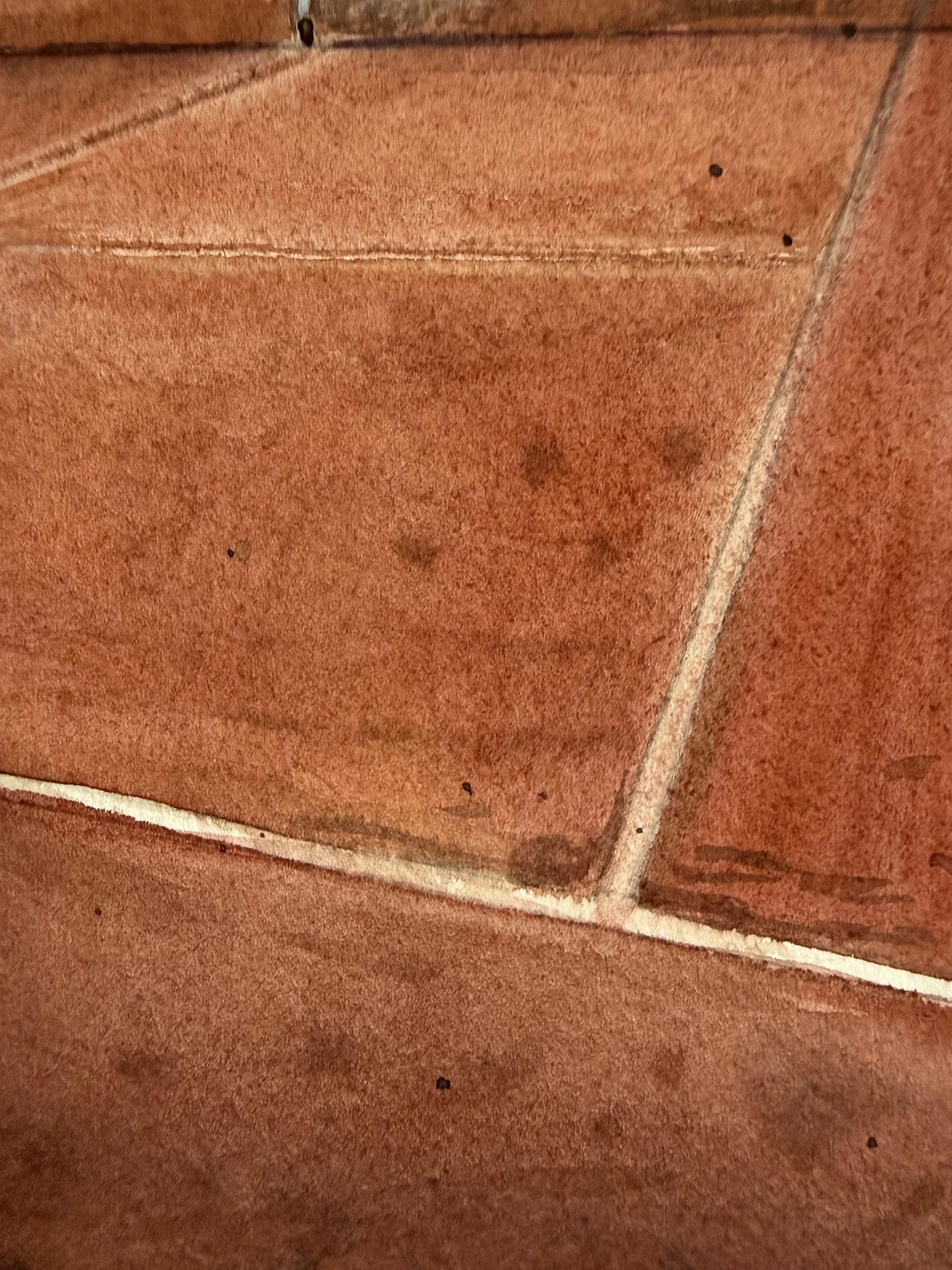 Close-up detail of the clay court and ball marks in Before the Serve