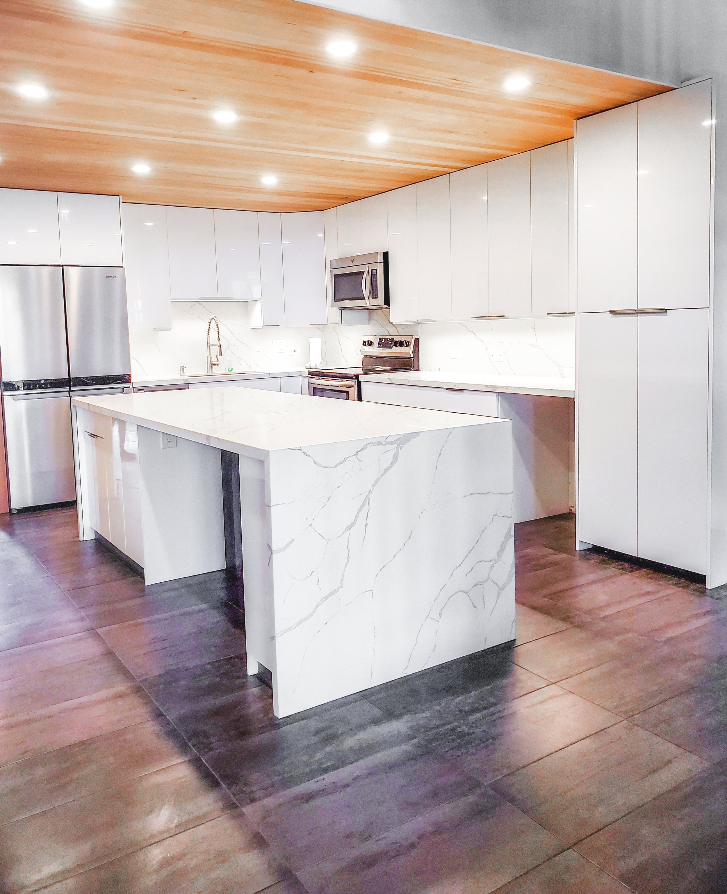 Handyman Service includes home renovations and remodel of  apartments, condos and homes. Modern custom kitchen with white cabinets, granite island countertops and backsplash, stainless steel kitchen appliances and new tile flooring.