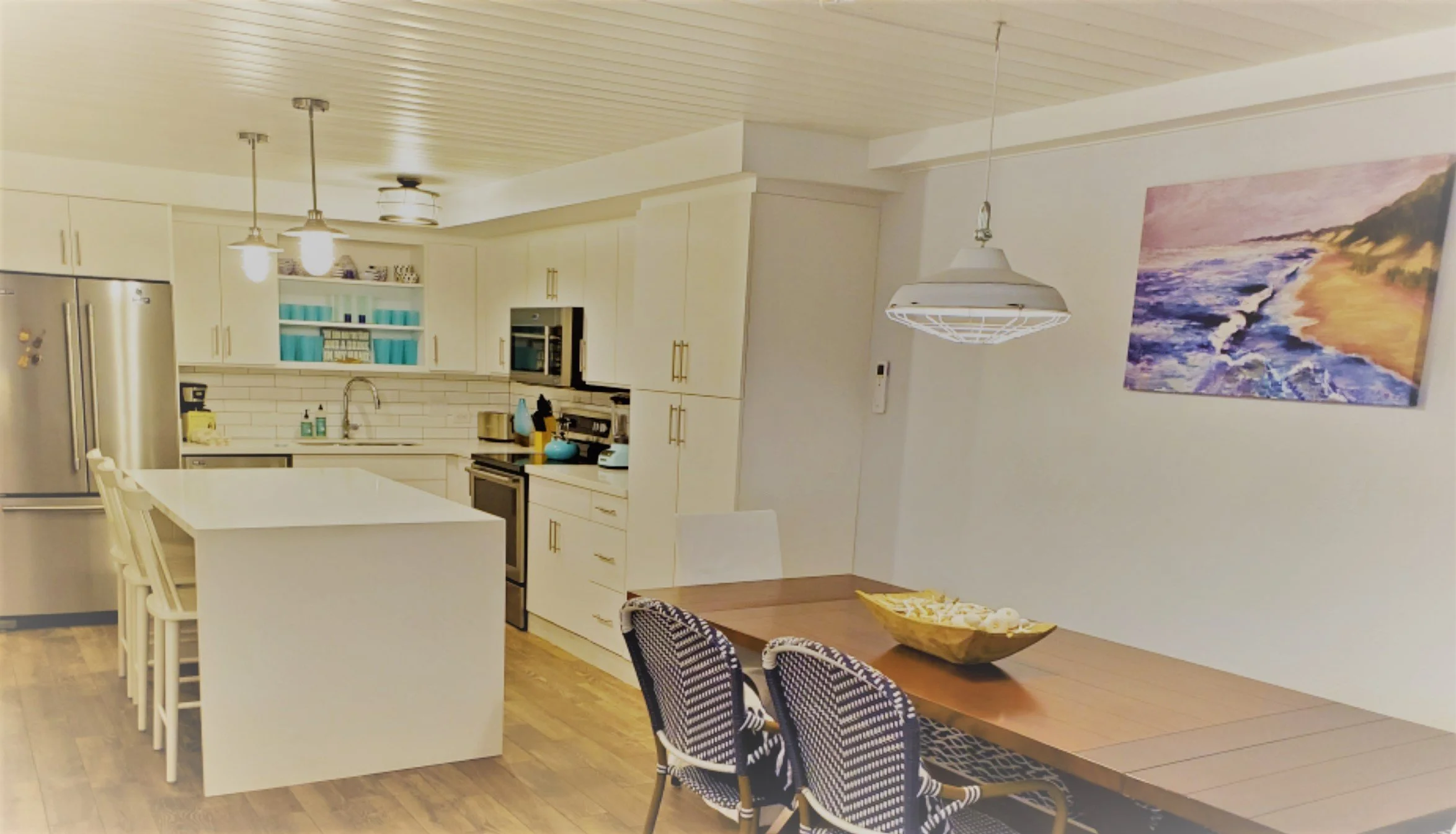Bright, modern kitchen with white cabinets, a white island. Custom remodel