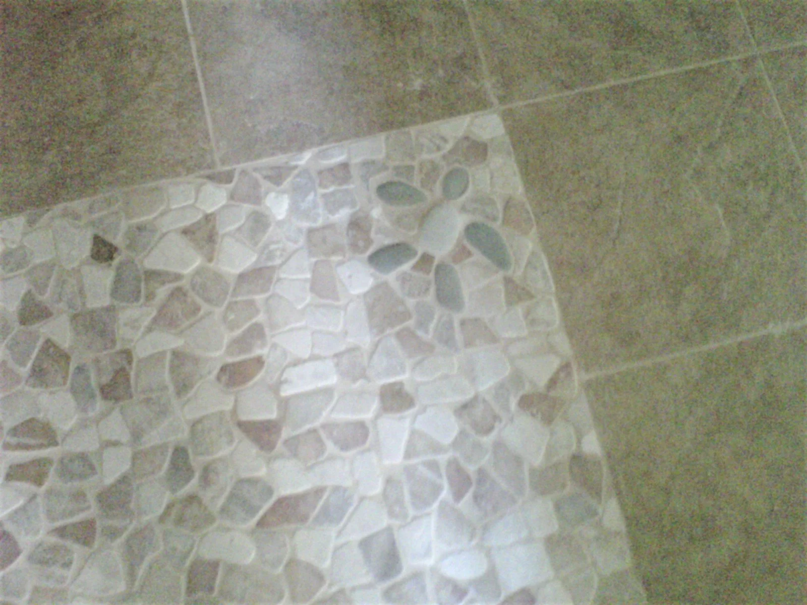 Tile floor install of decorative mosaic-stone tile in a custom pattern 