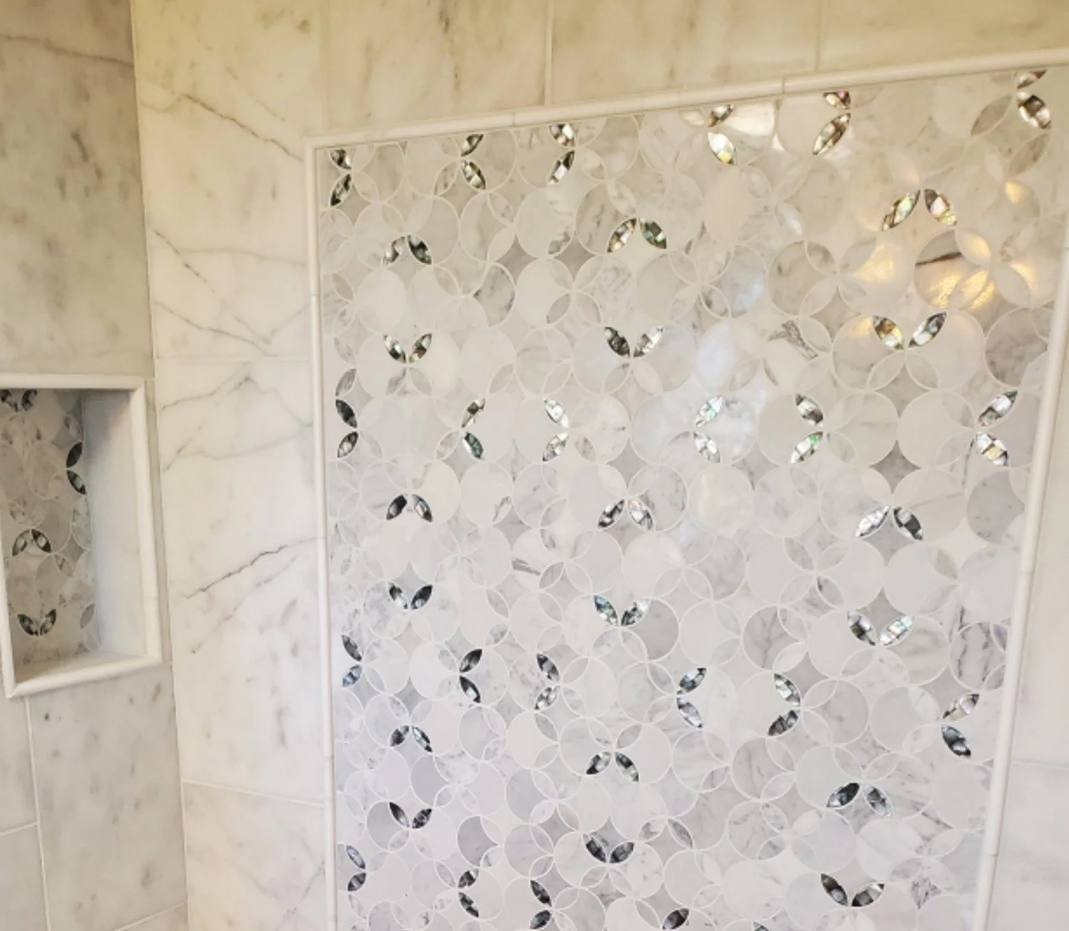 Handyman Service includes Bathroom renovation with custom tile and marble shower wall and custom built niche
