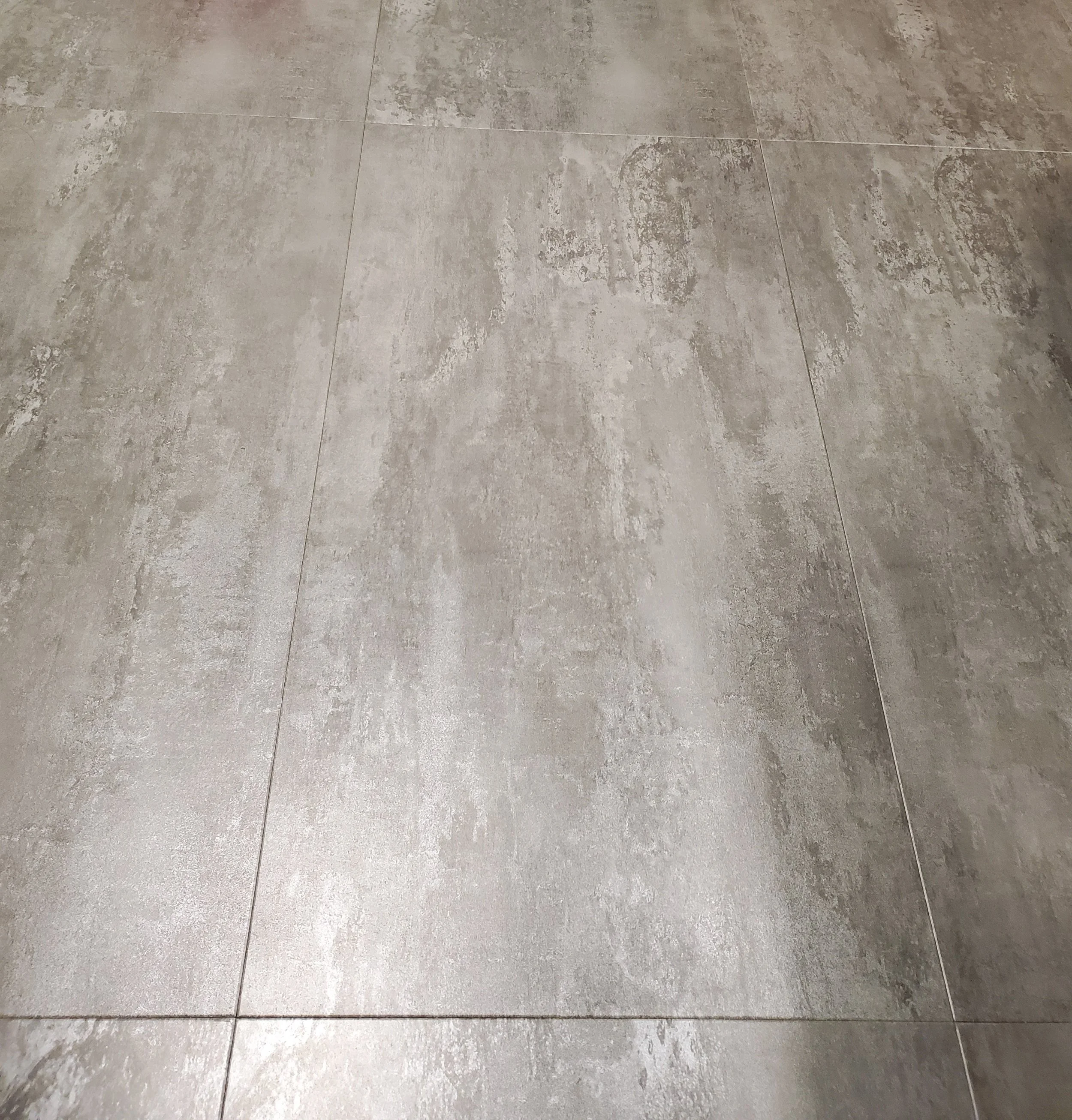Handyman Service includes tile installation. Close-up of a new installed tiled stone floor