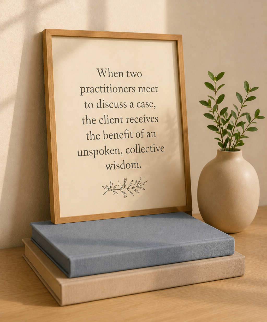 Framed quote about case consultation beside stacked books and a vase with greenery.