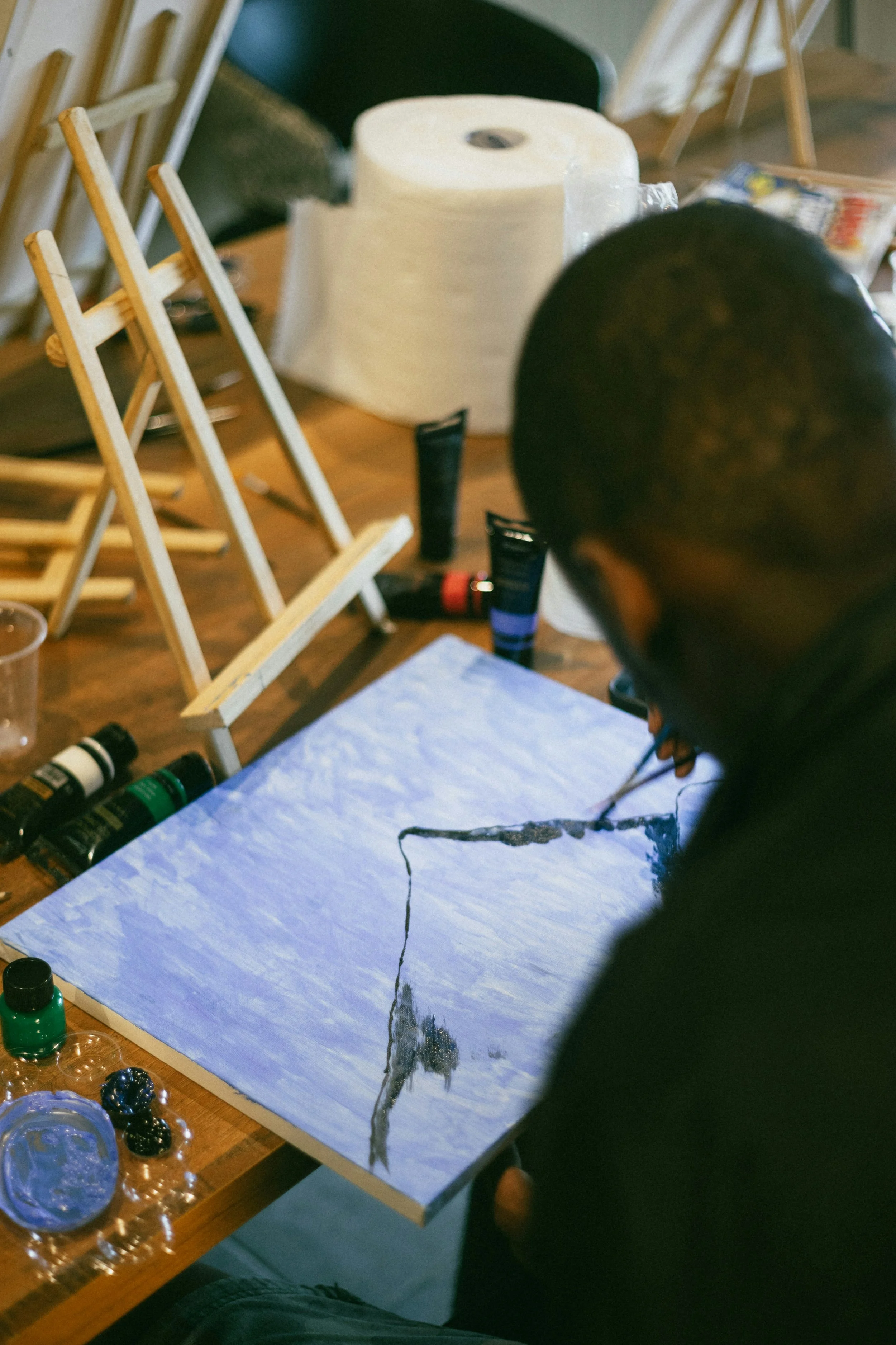 A student focused on a painting project