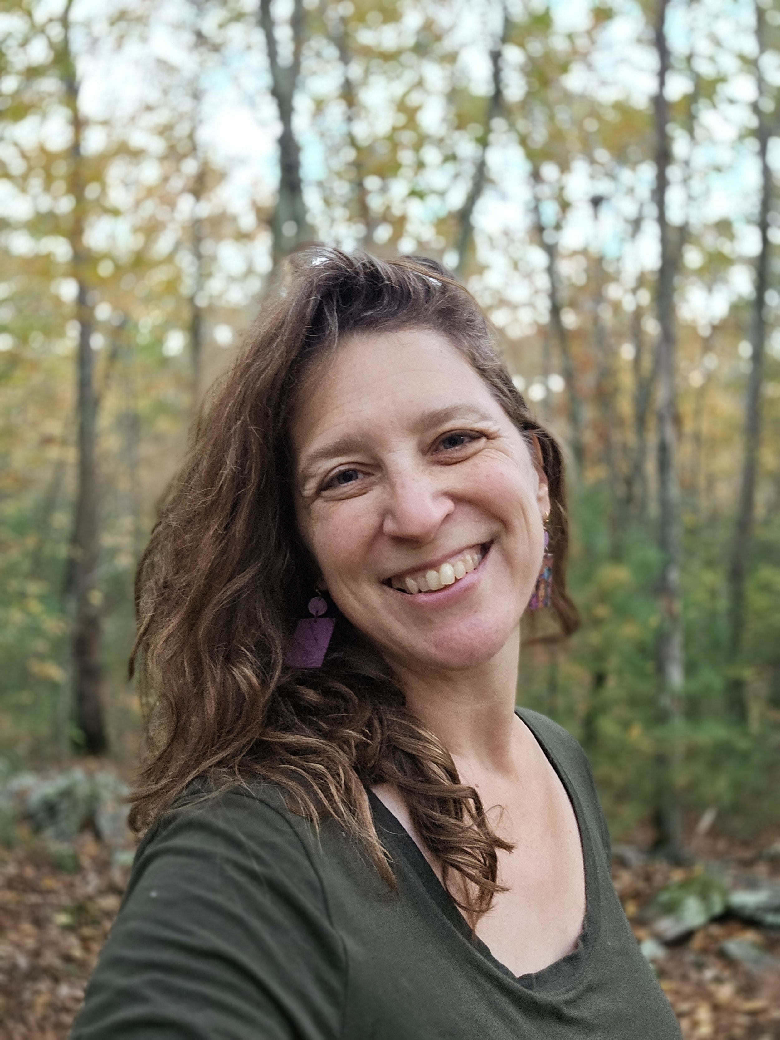 Headshot of the author in the woods