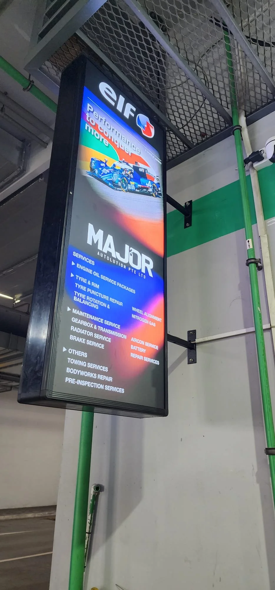 Digital signboard advertising automotive services at Majors Autolution Pte Ltd, including engine oil, tyre, wheel alignment, maintenance, repair services, and more.