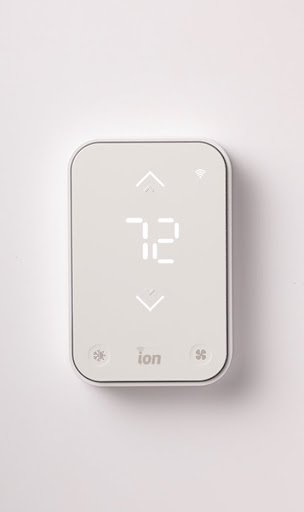 Digital thermostat displaying temperature setting of 72 degrees with icons for brightness, ion mode, and fan speed.