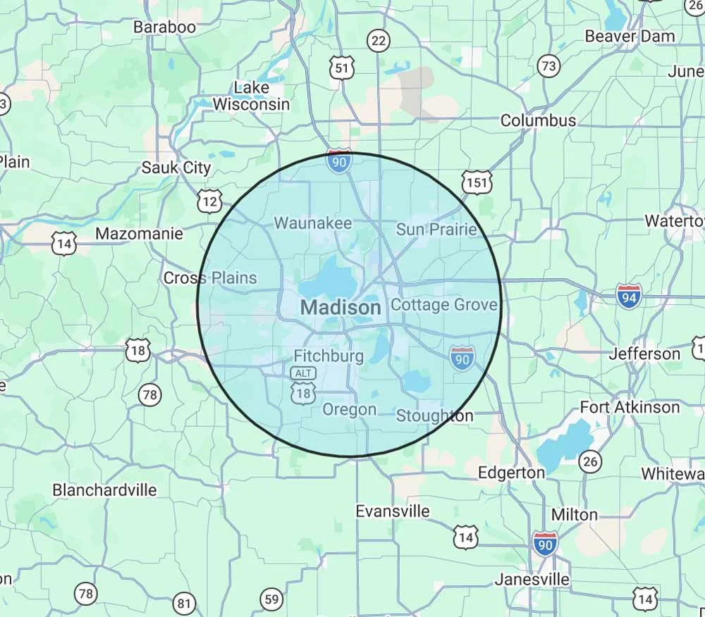 Map of Madison, Wisconsin, with a highlighted circular area covering the city and nearby towns like Fitchburg, Sun Prairie, and Oconomowoc.