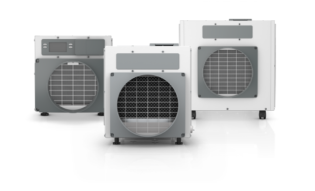 Three industrial air conditioning units or chillers against a black background.