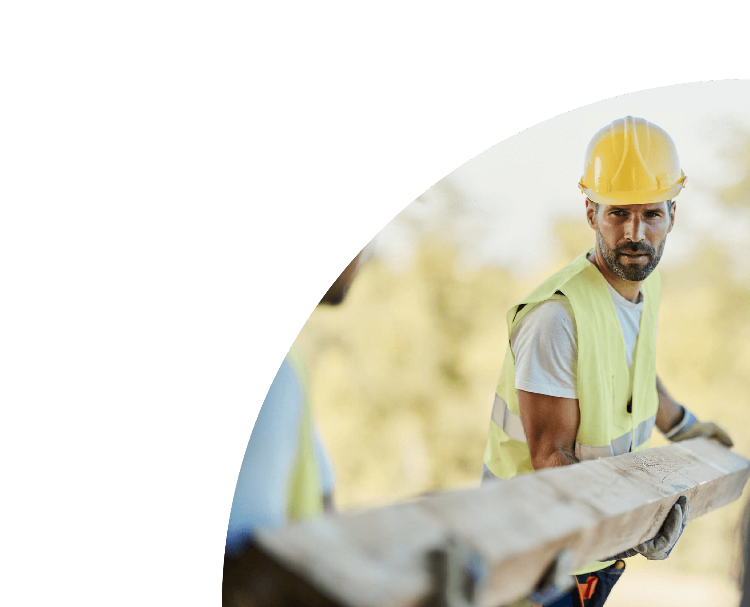 Construction worker wearing a yellow helmet and a reflective safety vest working outdoors.