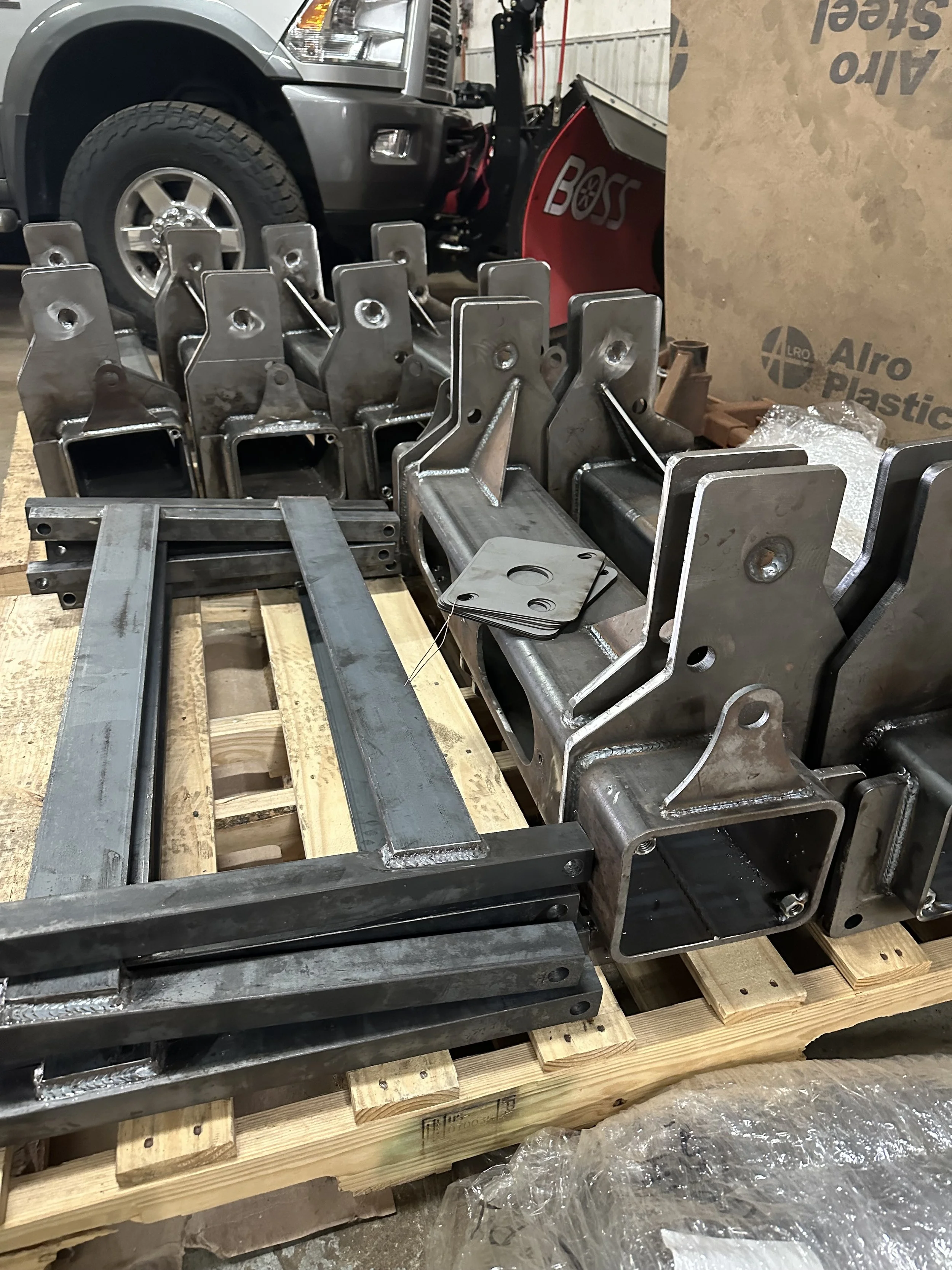 back blade snow plow parts snow plow pump box and a snow plow attachment in a workshop or storage area