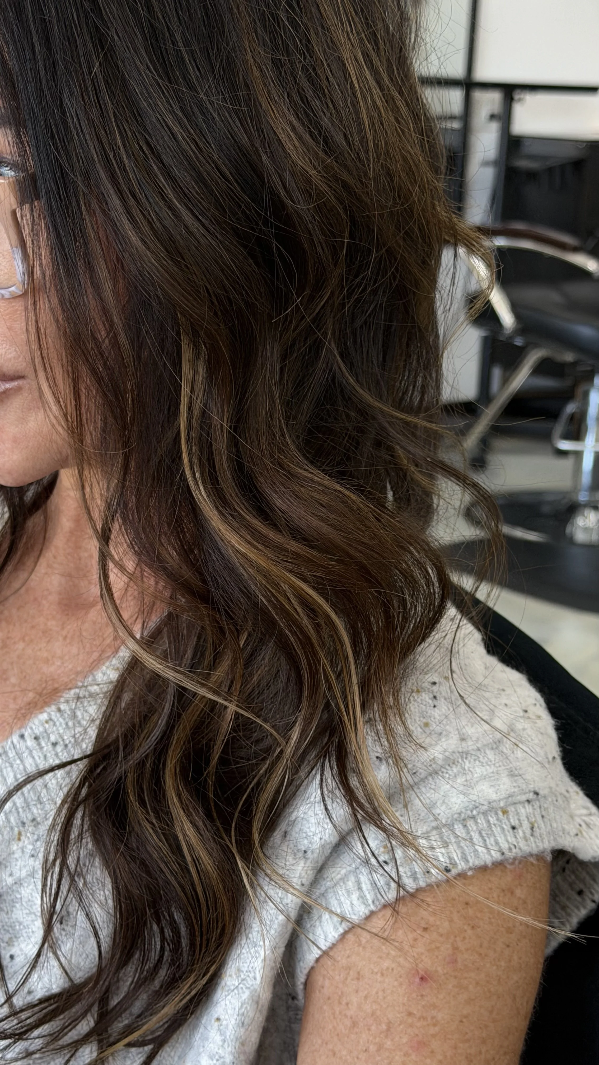 She's at the hair salon, getting her K tip keratin bonds added in around her face