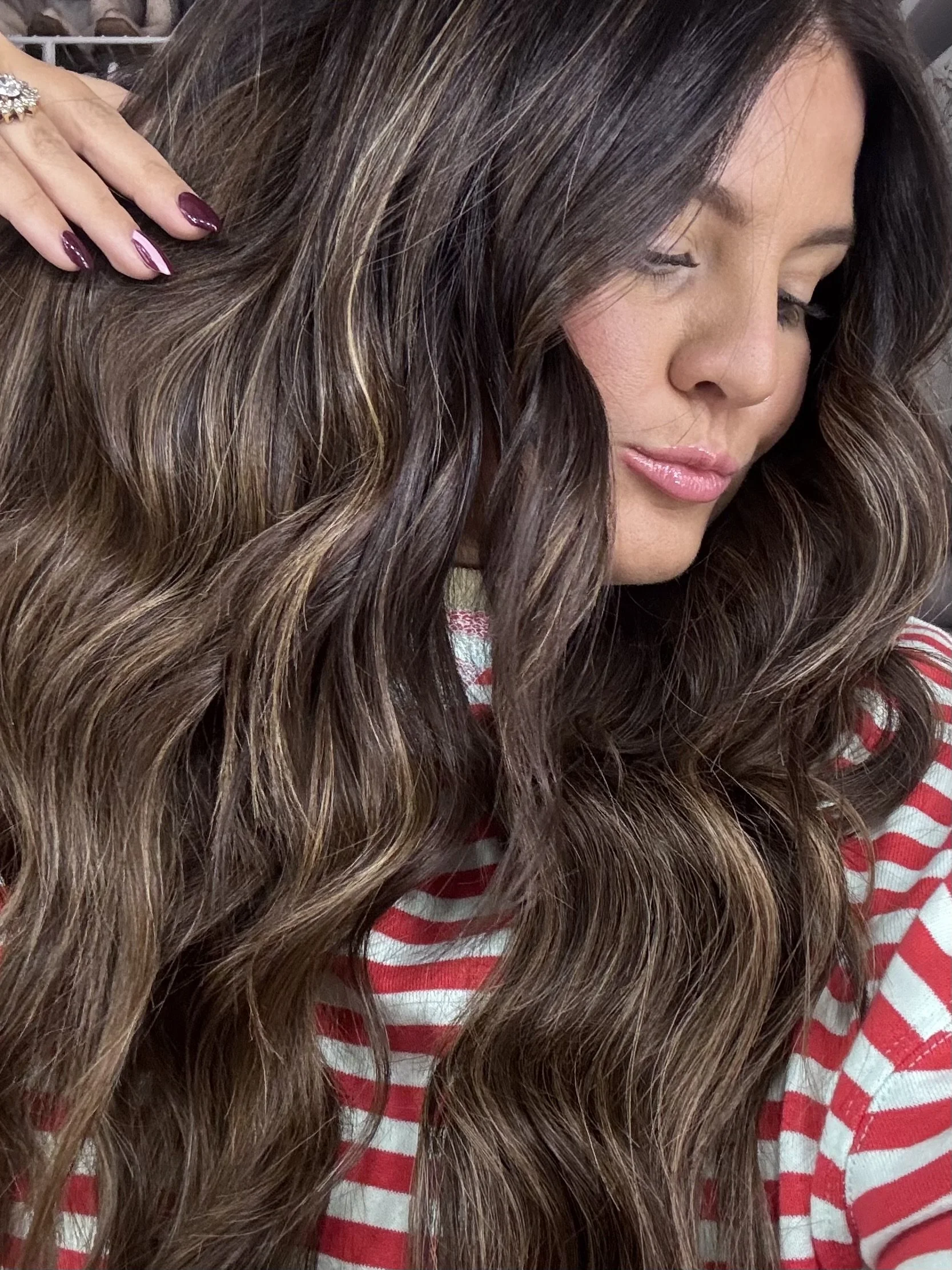 Beautiful young girl with gorgeous wavy, shiny extensions added in 22 inches in length