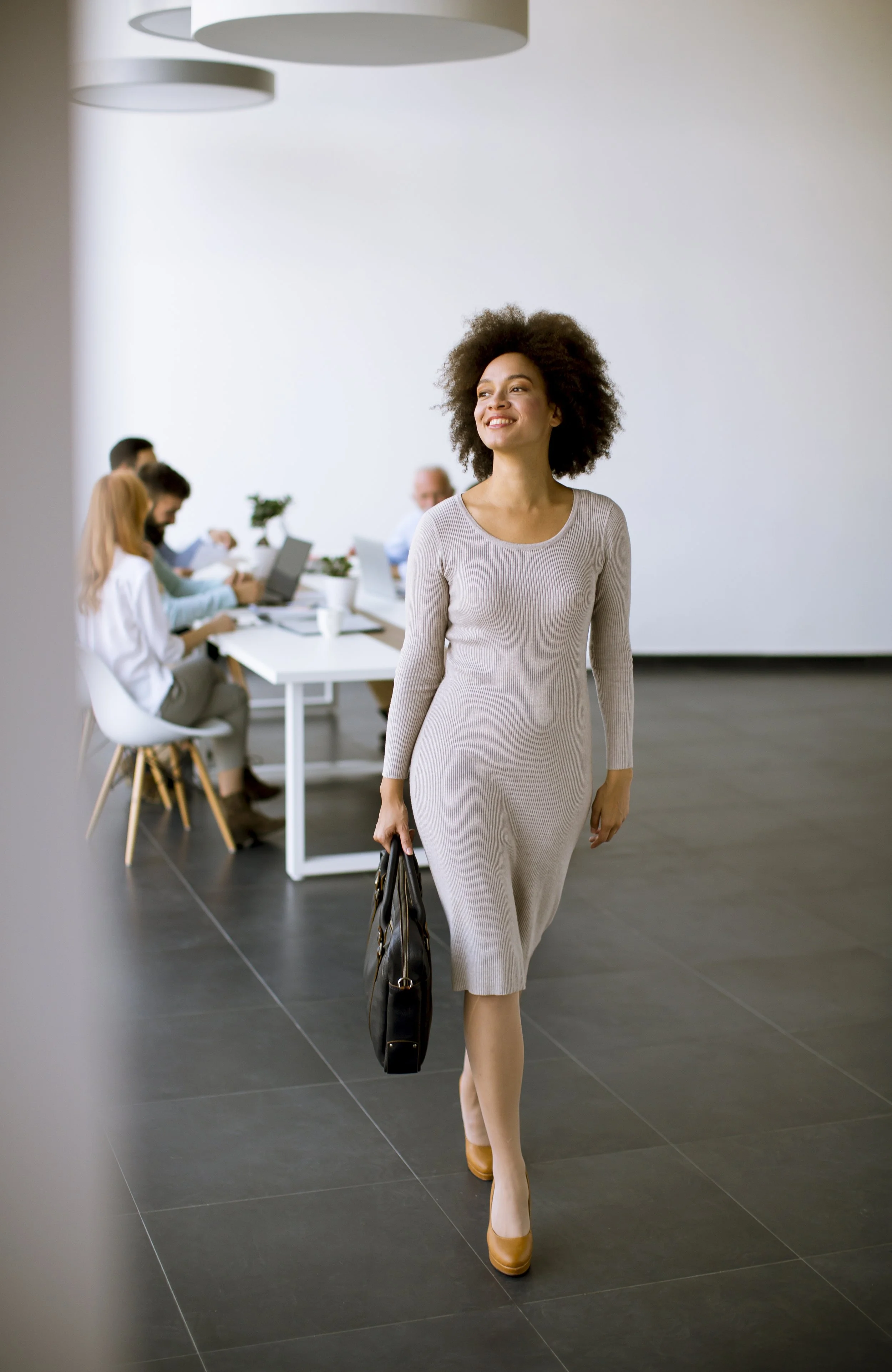 Experience of Time client walking confidently through modern office, representing reclaimed time and executive lifestyle management