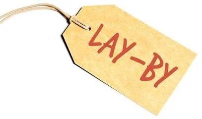 A beige tag with a string attached, with the words 'LAY-BY' written in red.