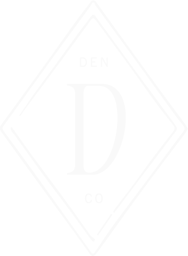 Design with the letter 'D' in the center, surrounded by the words 'DEN' at the top and 'CO' at the bottom, all within a double diamond outline.