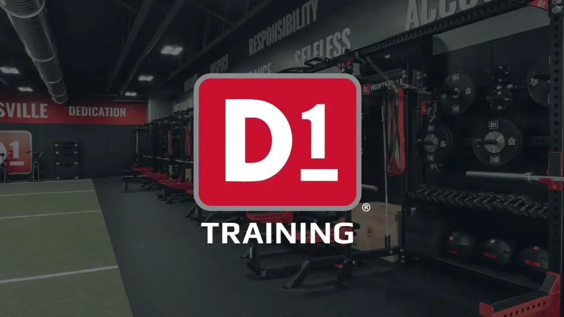 Empty fitness training gym with weightlifting equipment and a large red and white D1 Training logo in the foreground.