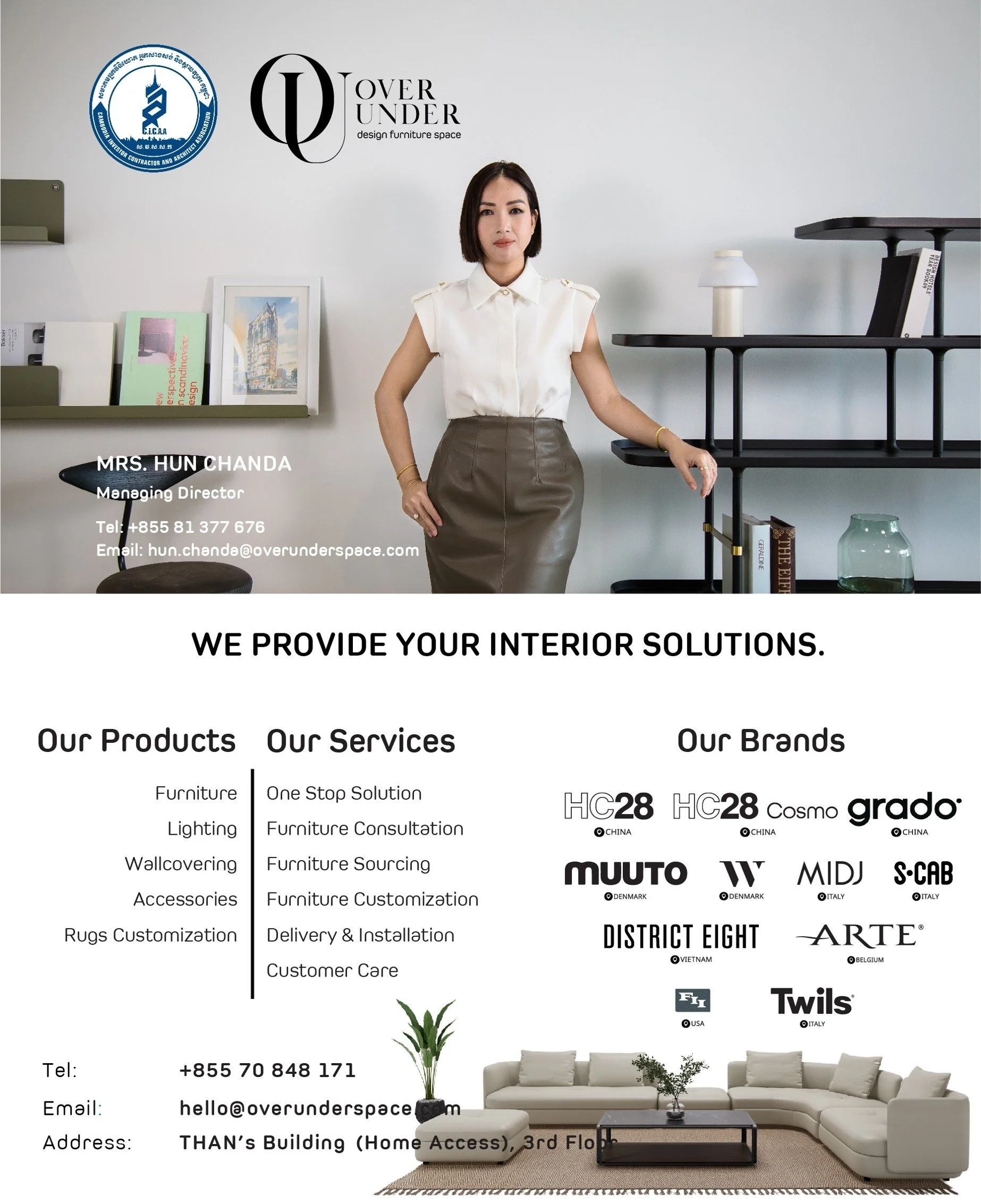 Interior design office with branding and furniture displays, featuring a woman standing with her arm resting on a black shelf. The image shows branding logos, product and service descriptions, and contact information for a company specializing in interior solutions, along with a living room setup with a white sectional sofa, gray pillows, a black coffee table, and a beige rug.