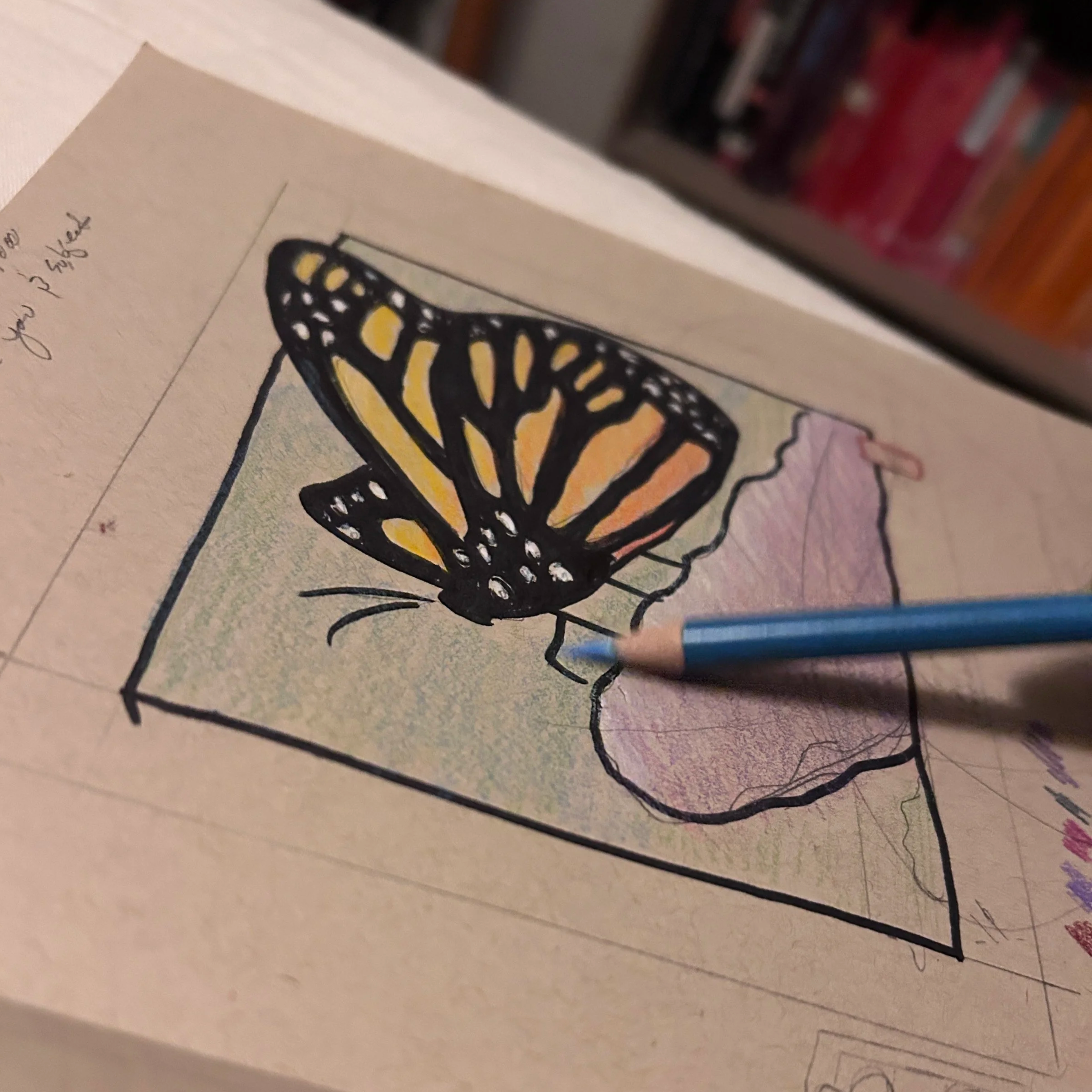 Close-up of a printed butterfly illustration on a piece of paper with handwritten notes.