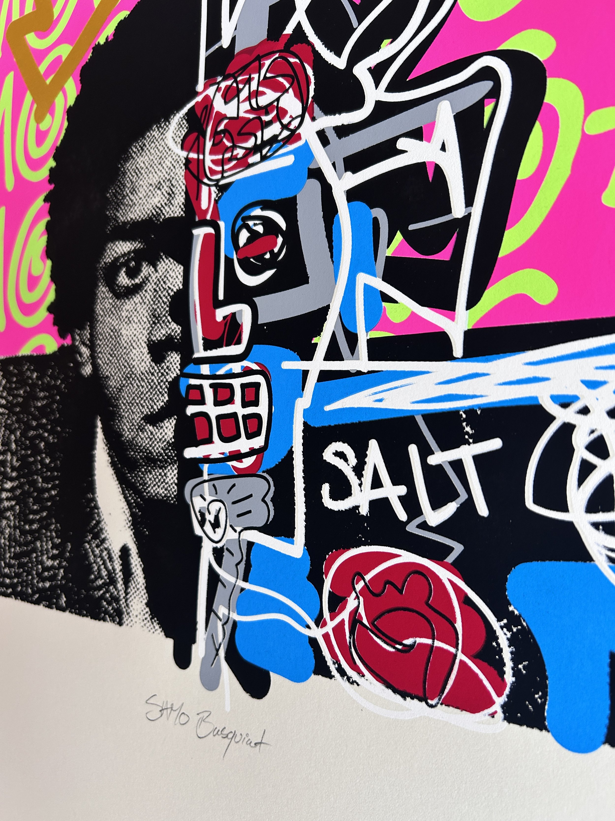 A piece of modern abstract art with vibrant colors, depicting a woman's face in black and white on the left side, and various shapes, lines, and faces in bright pink, red, blue, green, black, and gray on the right side, with handwritten text at the bottom.