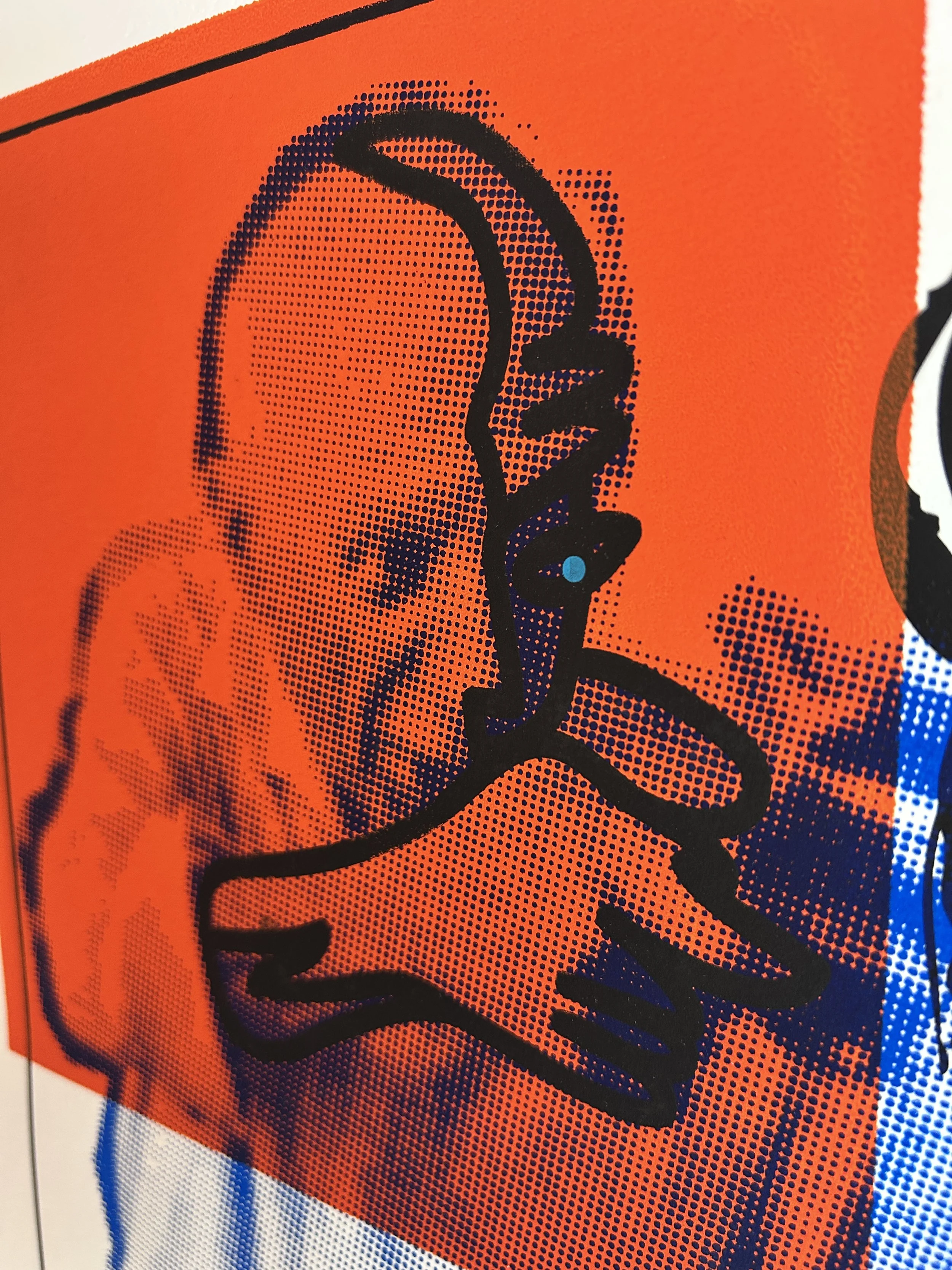 Close-up of a vibrant orange background with a stylized black signature and halftone dots.