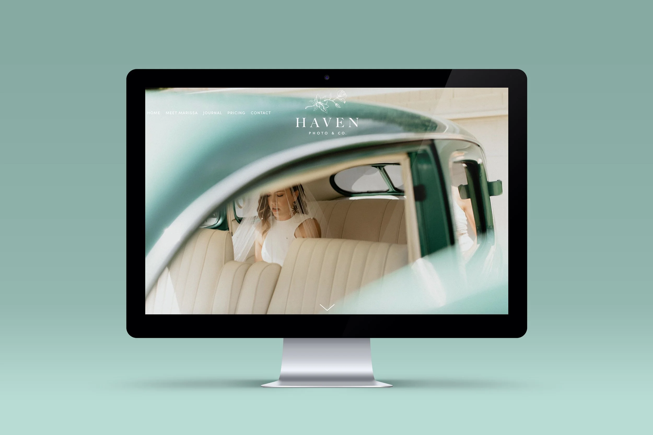 Computer monitor displaying a photo of a woman in a white dress sitting inside a vintage green car.