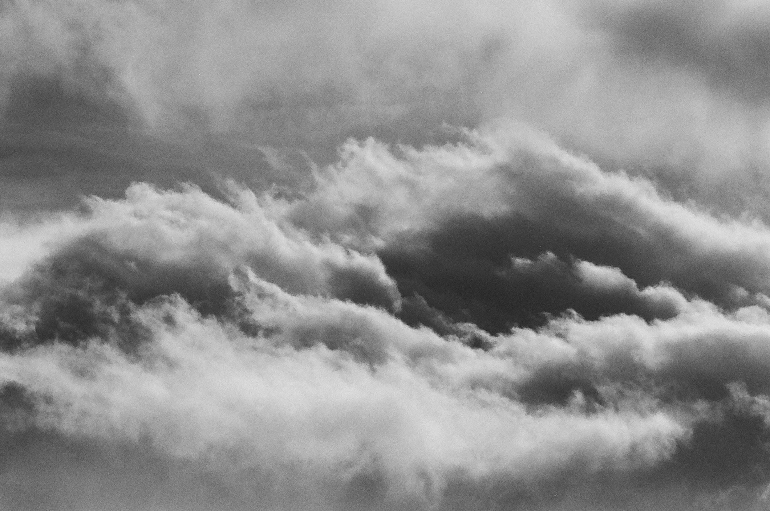 Black and white photograph of a cloudy sky with varying shades of gray.
