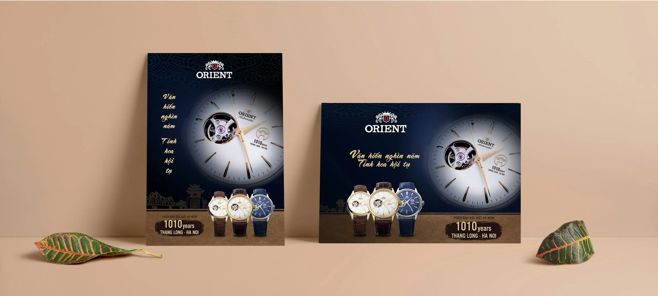 Two promotional posters for Orient watches featuring large watchface images and multiple wristwatch models displayed below, with decorative leaves at the bottom on a beige background.