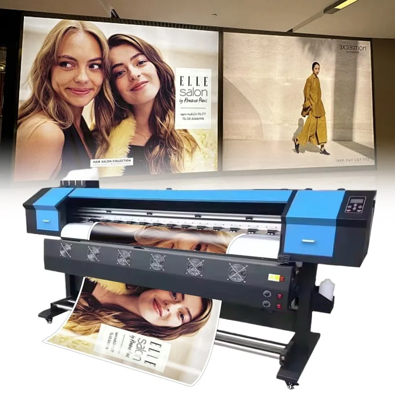 Large format printer printing a poster with two smiling women, one with long blonde hair and the other with long brown hair, in front of a billboard advertising Elle Salon.