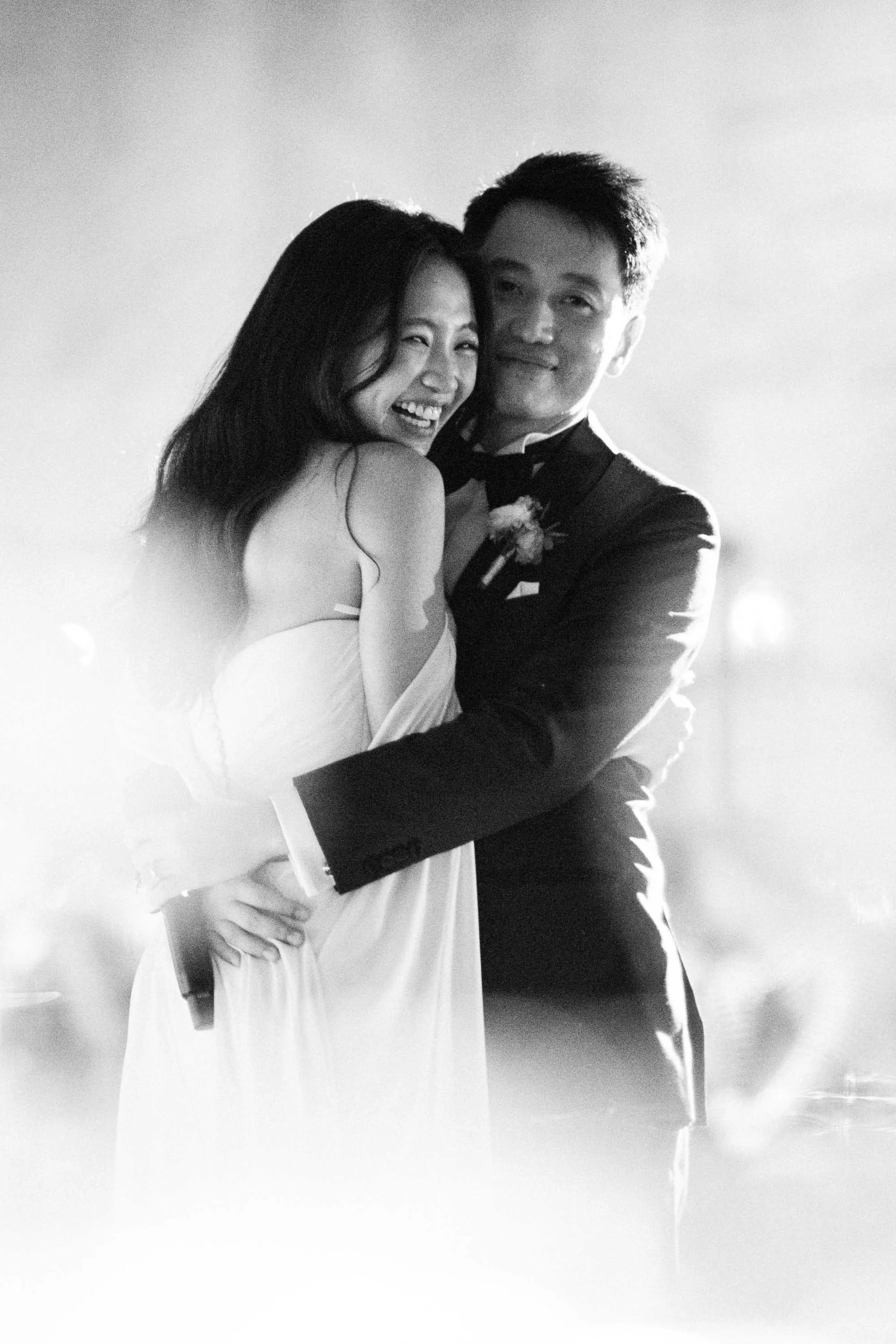 Bride and groom embracing during the wedding celebration.