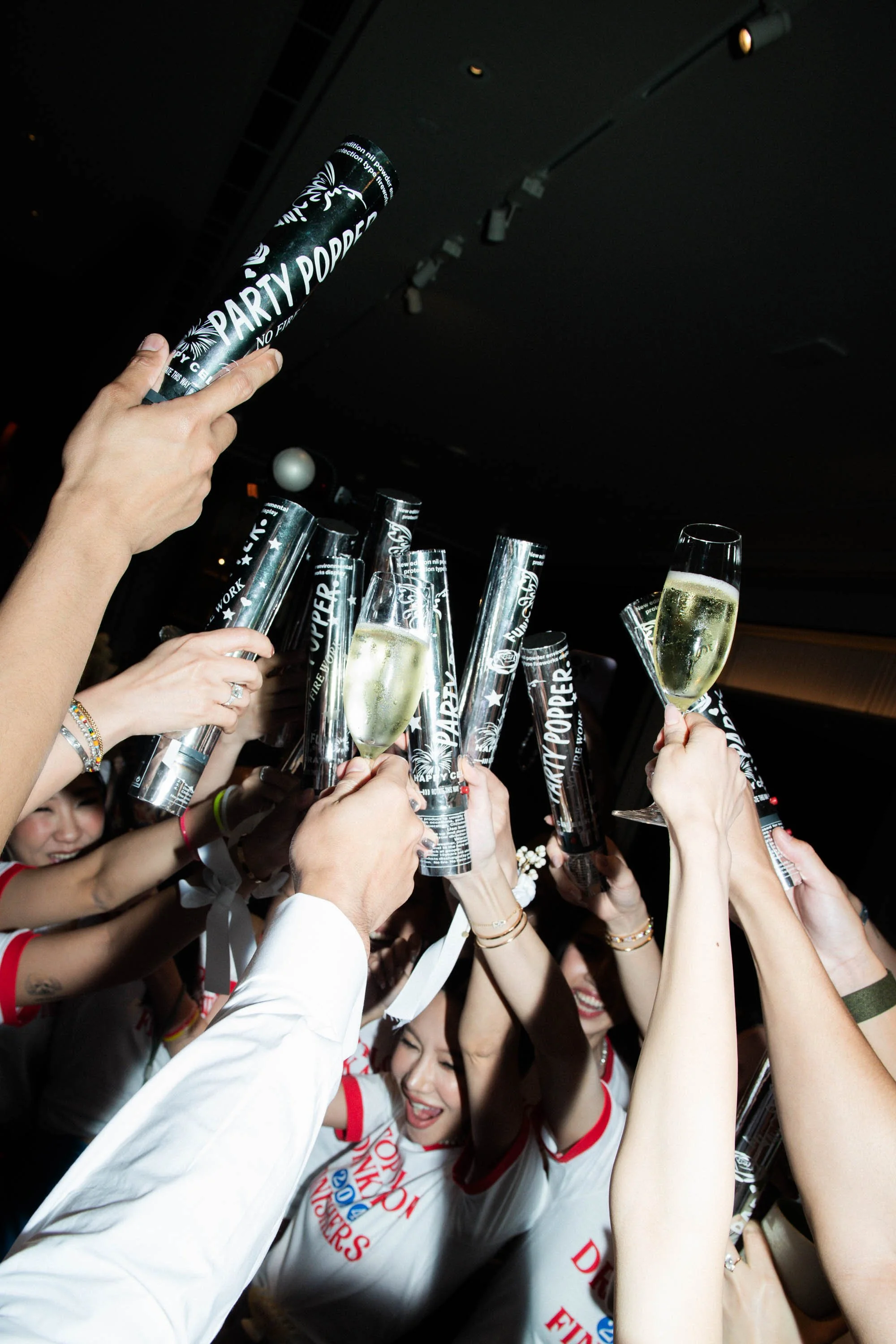 Friends preparing confetti launchers before the after-party entrance.
