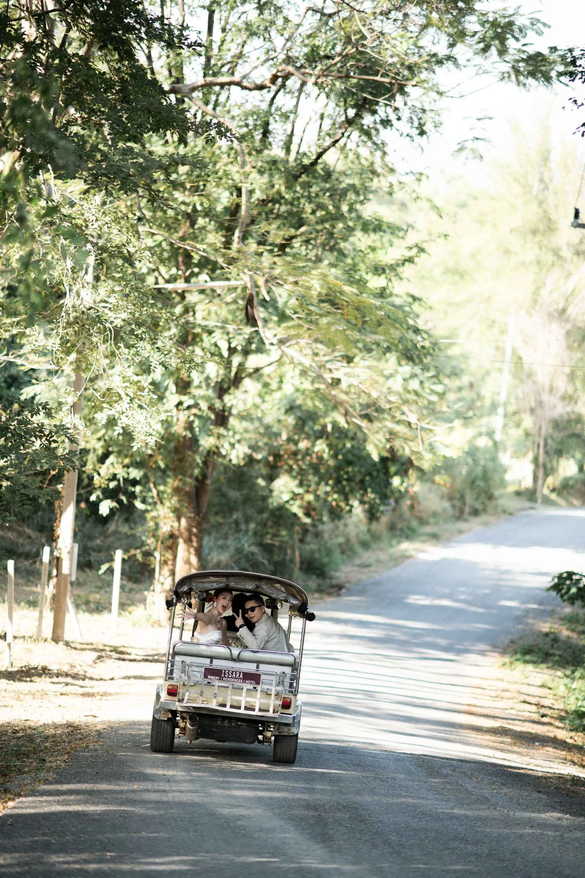 Bride and groom arriving at the wedding venue by tuk-tuk.