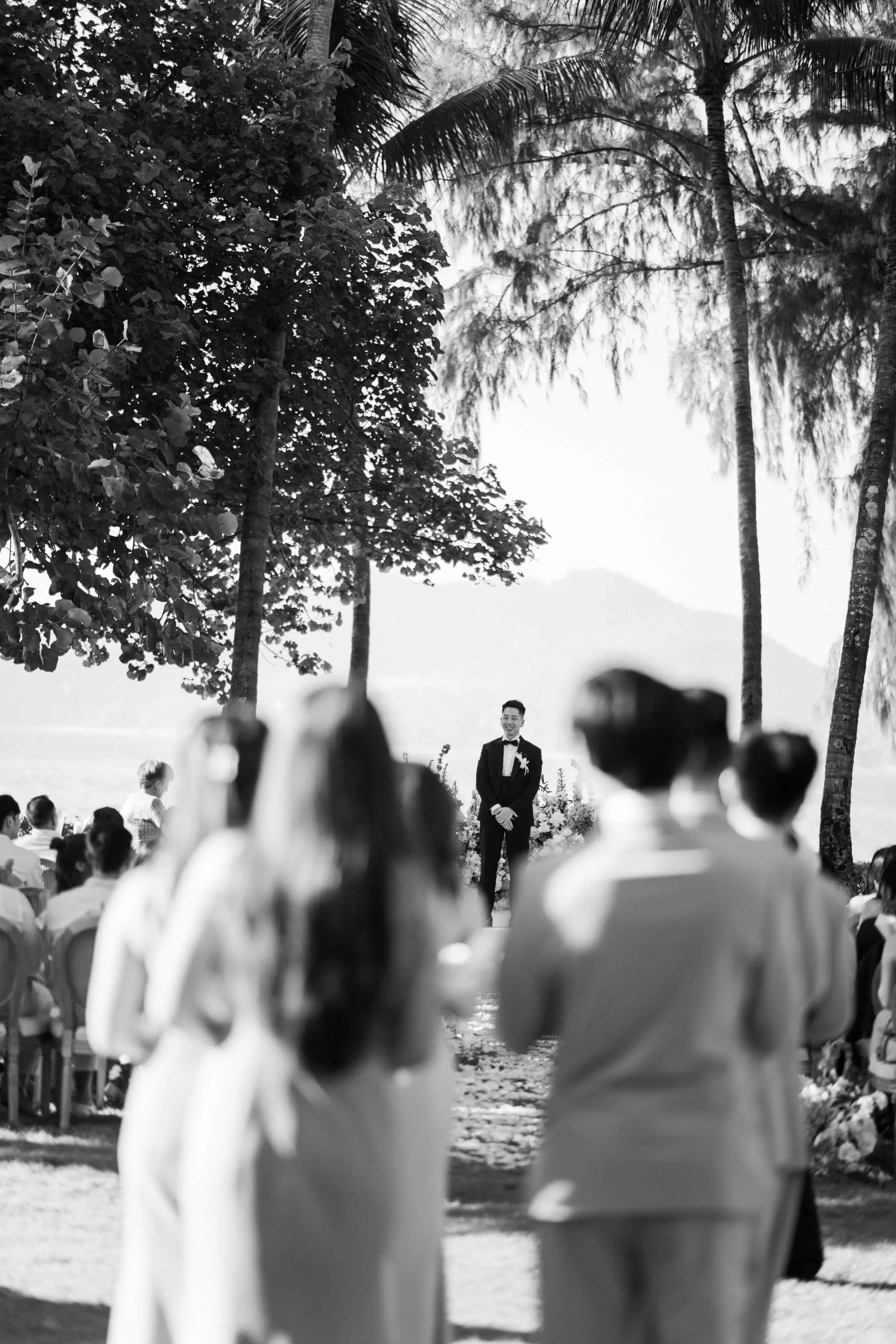 Groom waiting as the wedding party begins the ceremony entrance.