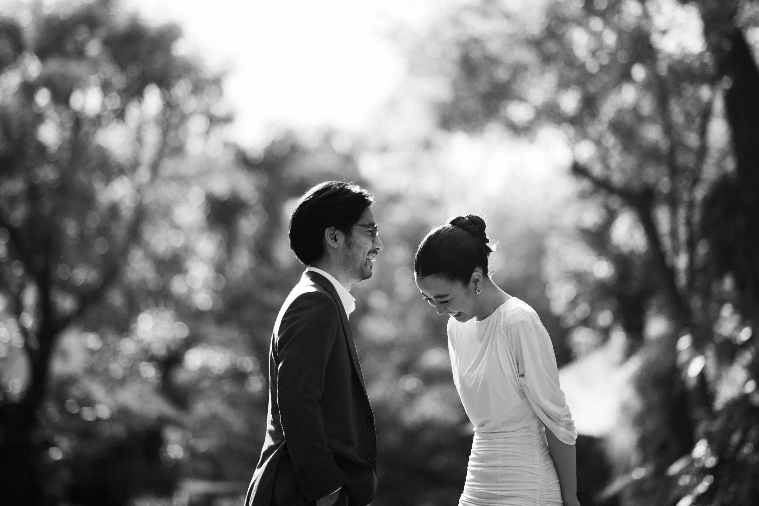 Couple facing each other and laughing together during their pre-wedding session.