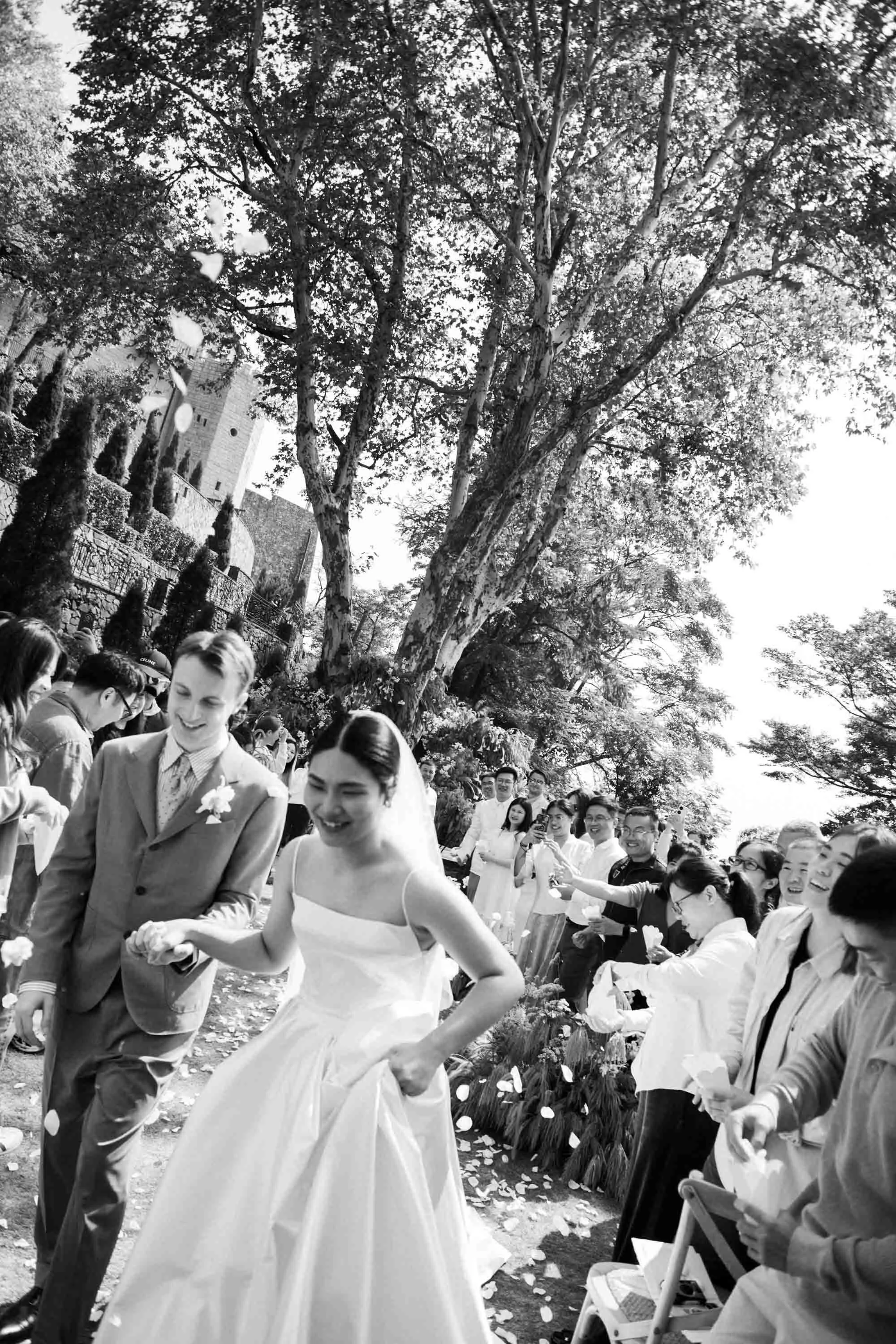 Bride and groom walking back down the aisle as guests celebrate.