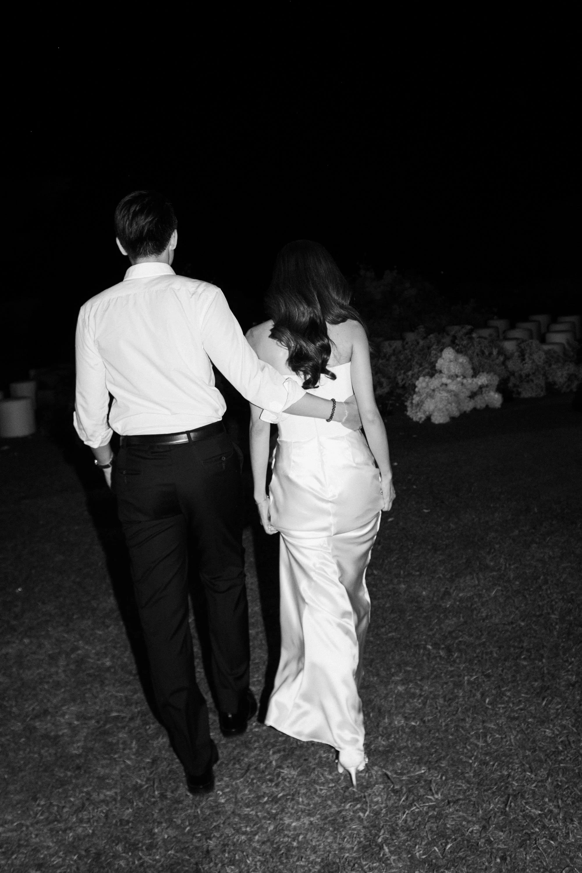 Bride and groom walking together during the reception.