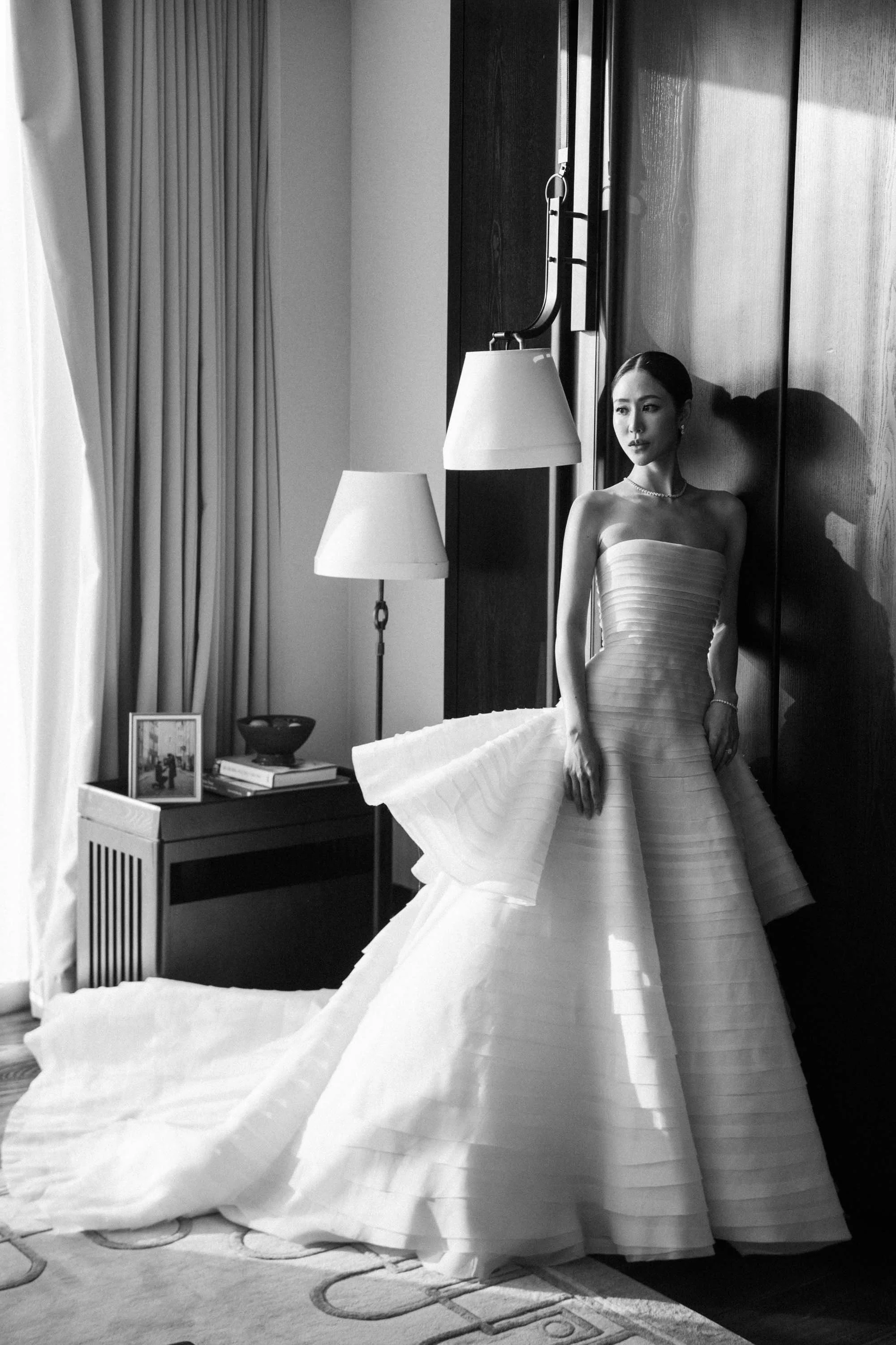 Bride standing in her wedding dress in the bridal suite.