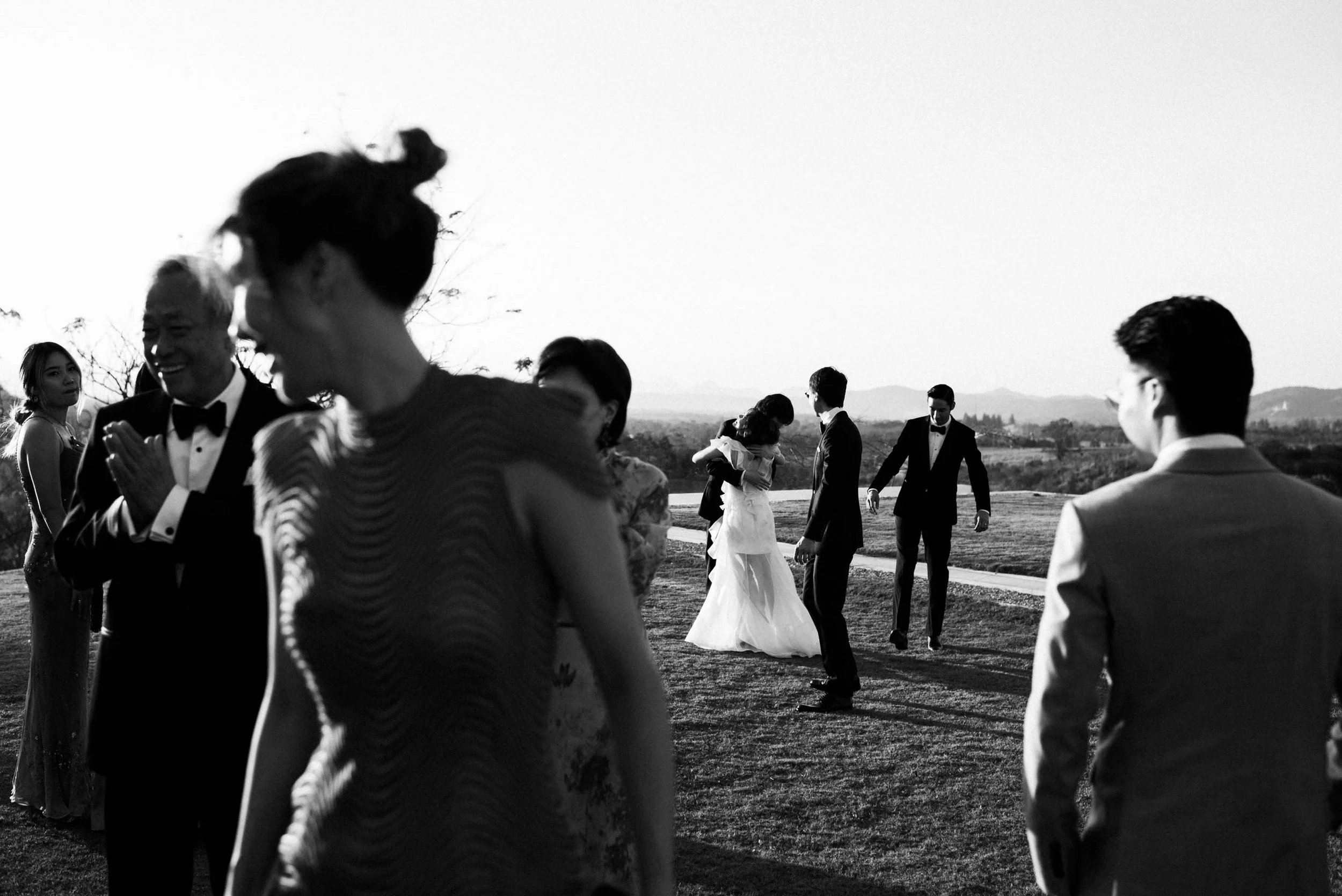 Bride hugging her brother during portraits with family and friends.
