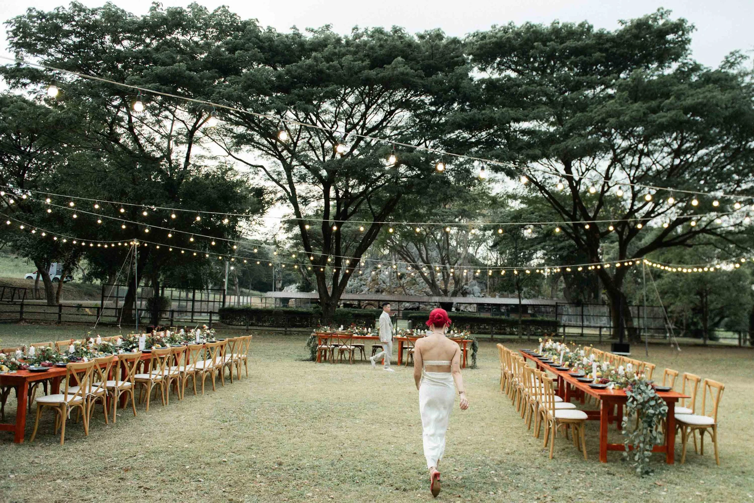 Bride and groom during a portrait session beside the reception long table.