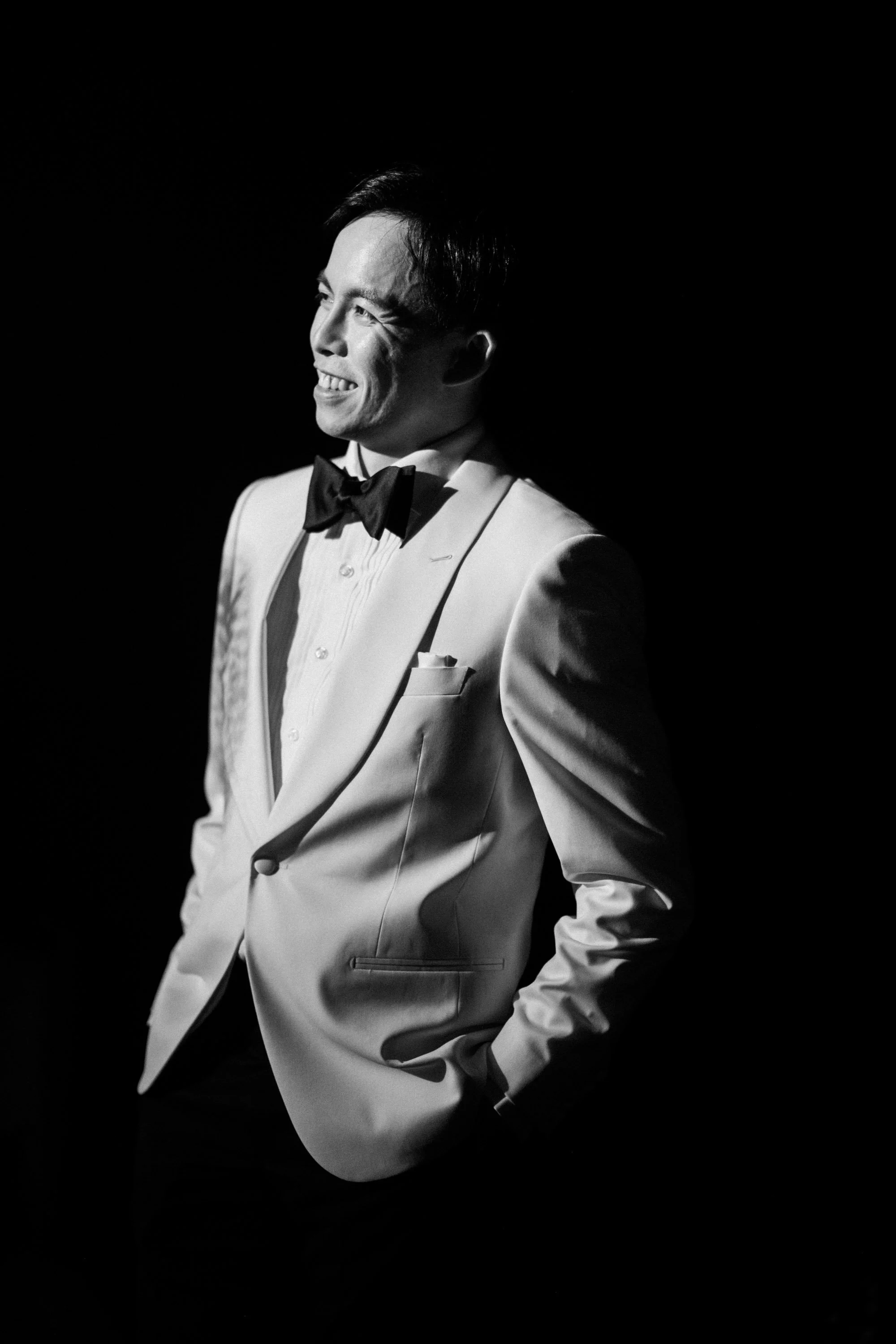 Groom standing in natural light before the ceremony.