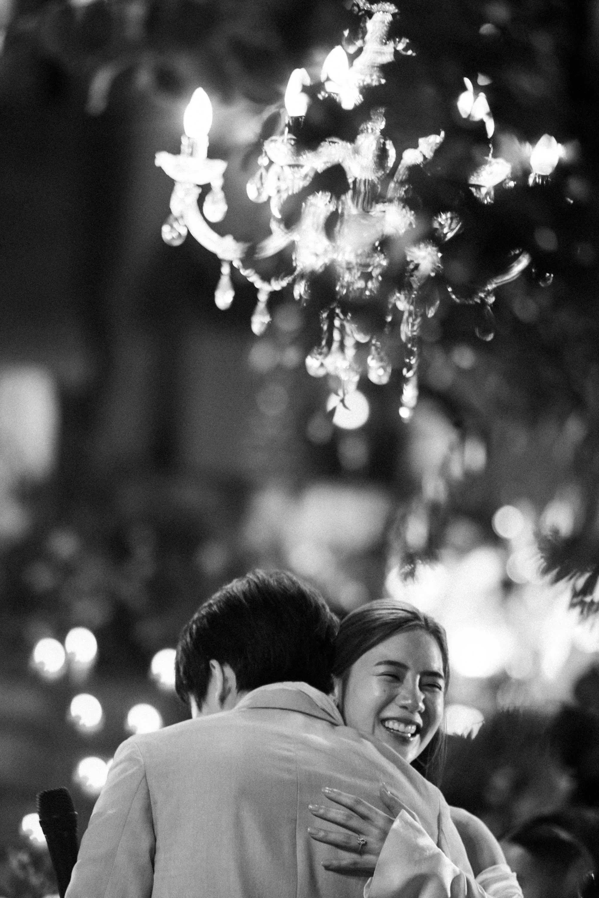 Bride and groom embracing after speaking to their guests.