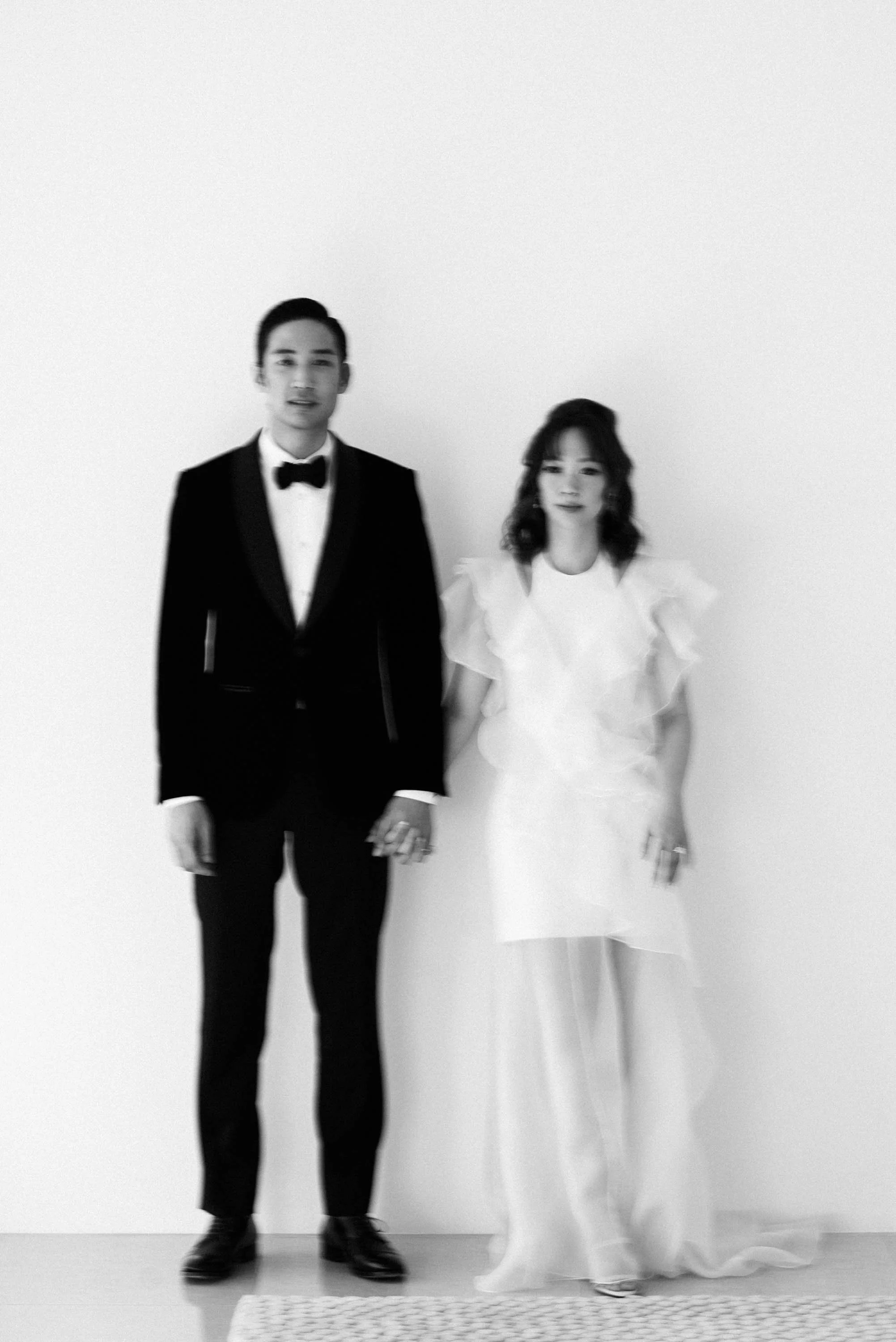 Bride and groom holding hands together in their dressing room before the wedding celebration.