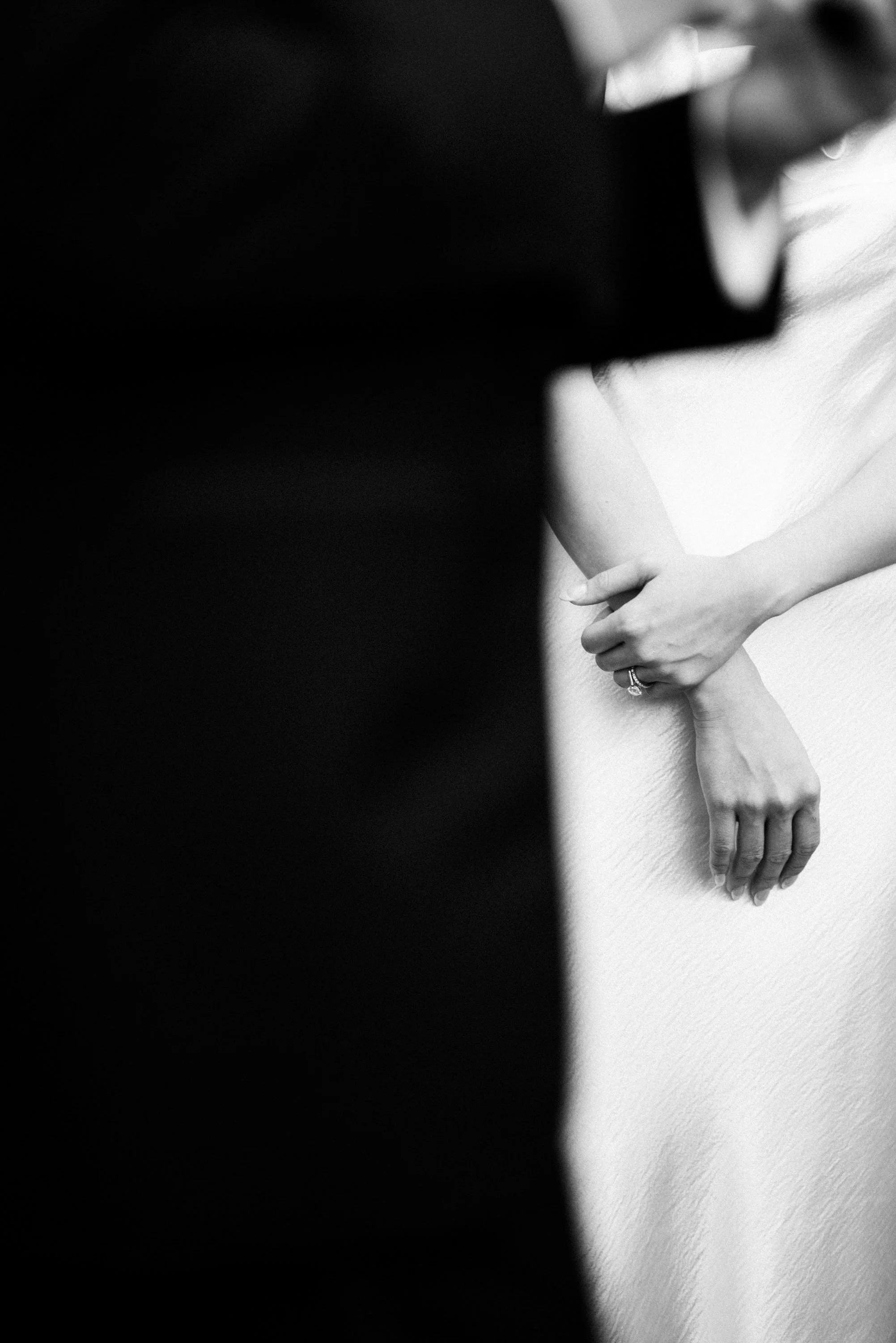 Close-up of the bride's hand as she listens to the groom's vows.