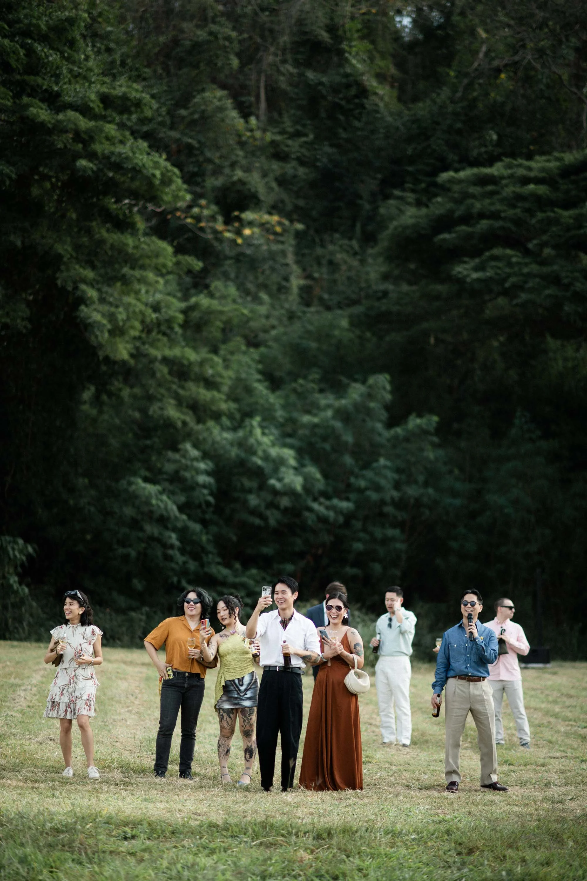Guests watching and photographing the couple during their portrait session.