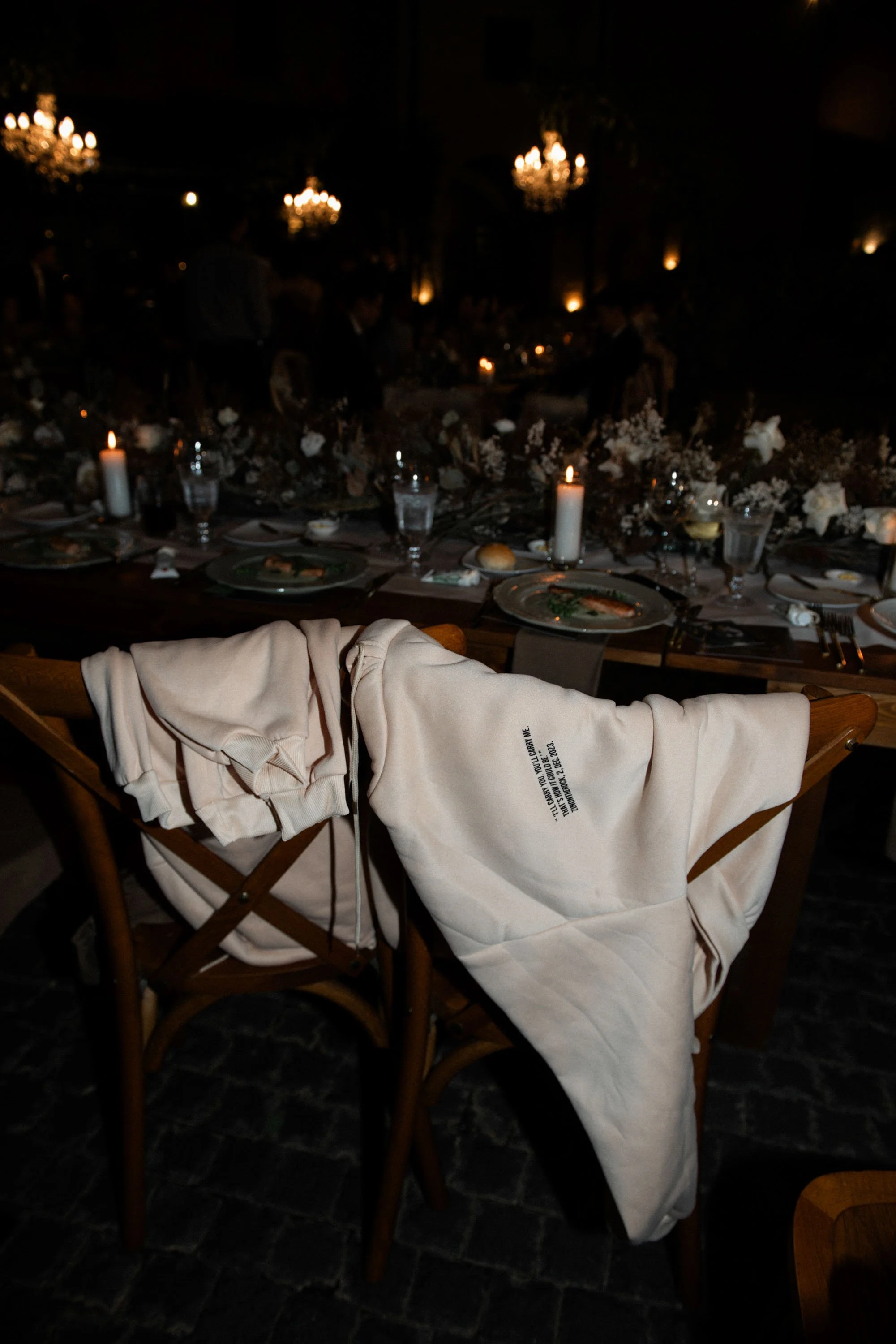 Hoodies prepared as wedding gifts for guests and draped over their chairs.