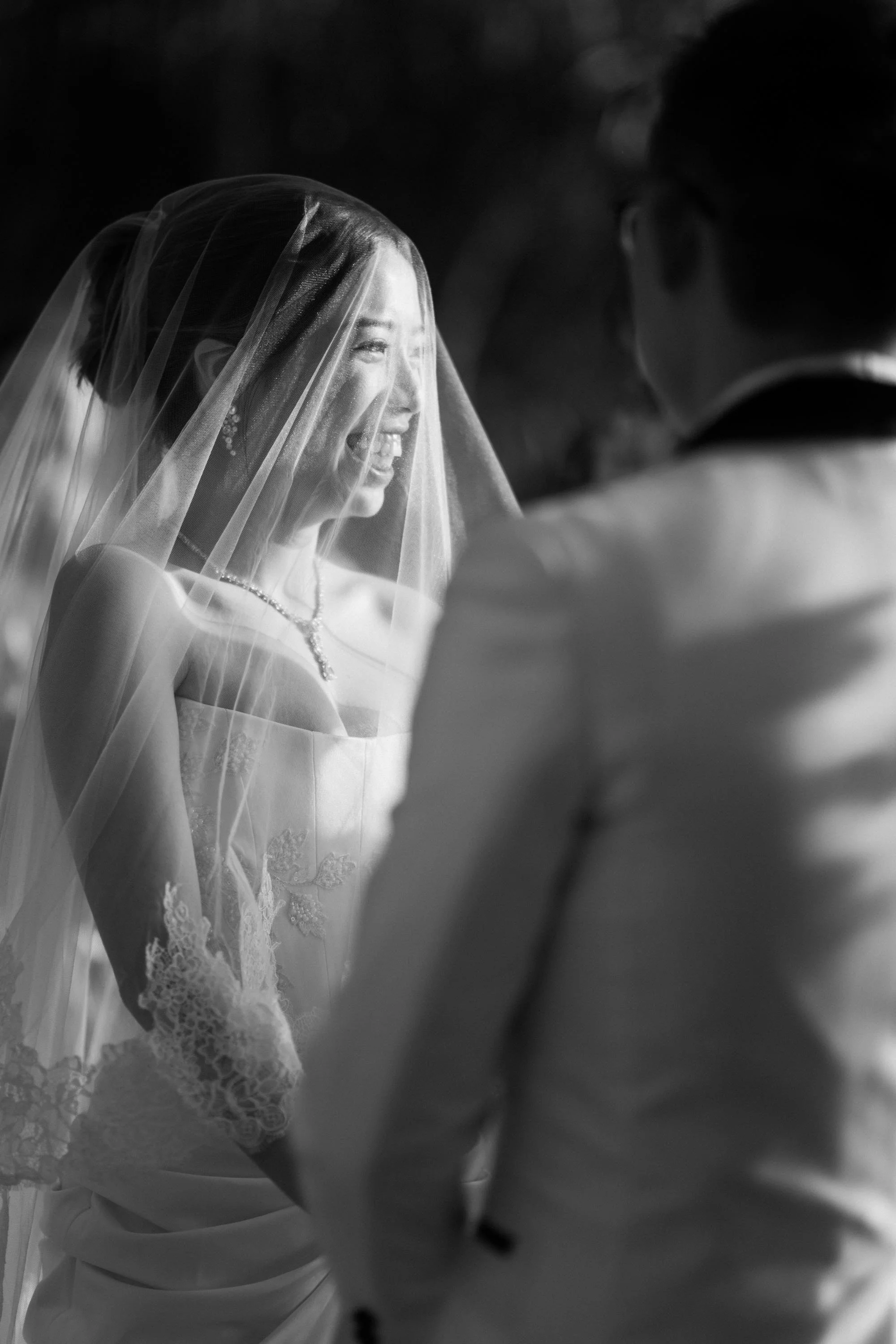Bride laughing while listening to the groom during the wedding vows.