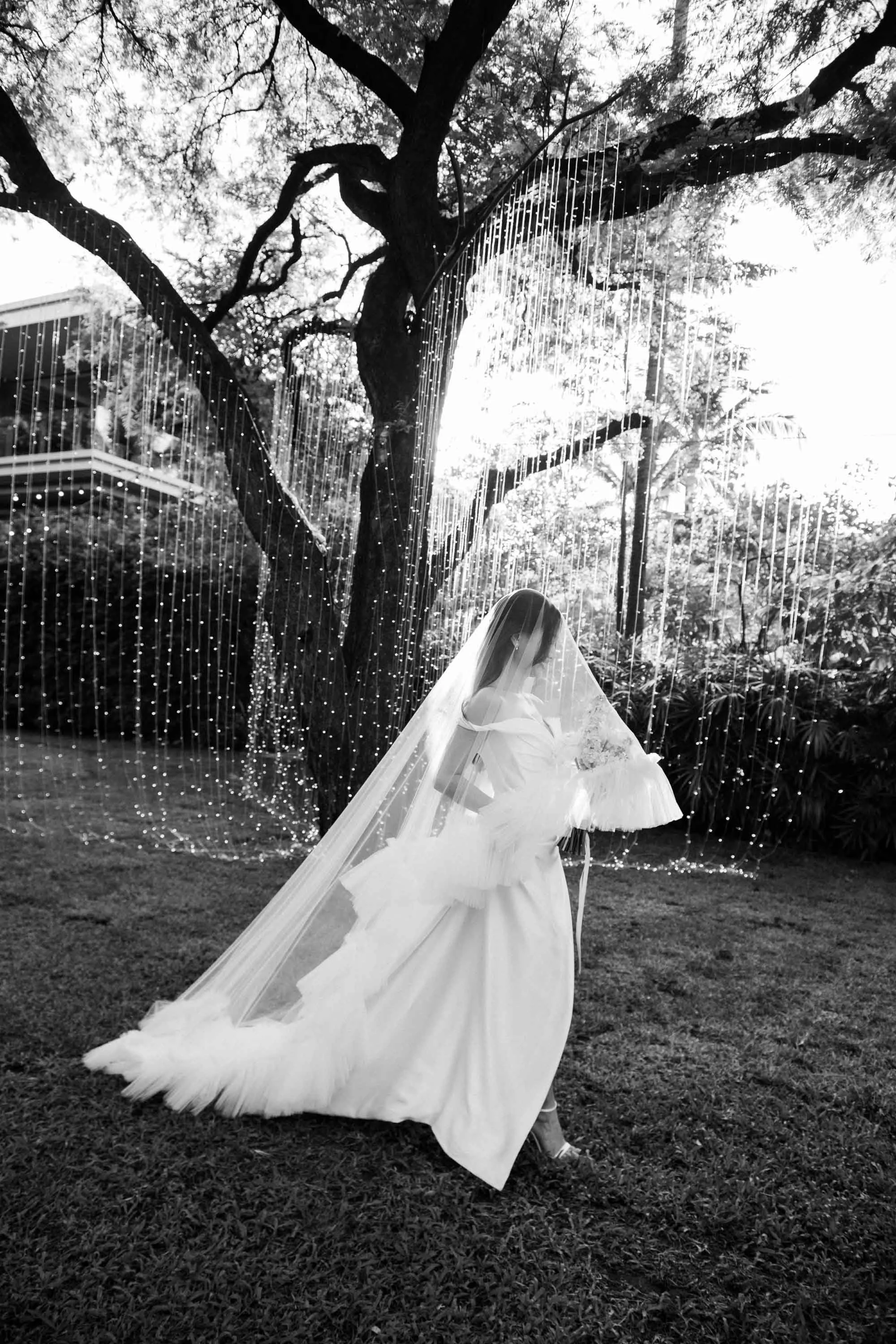 Bride walking through the garden toward the wedding ceremony.