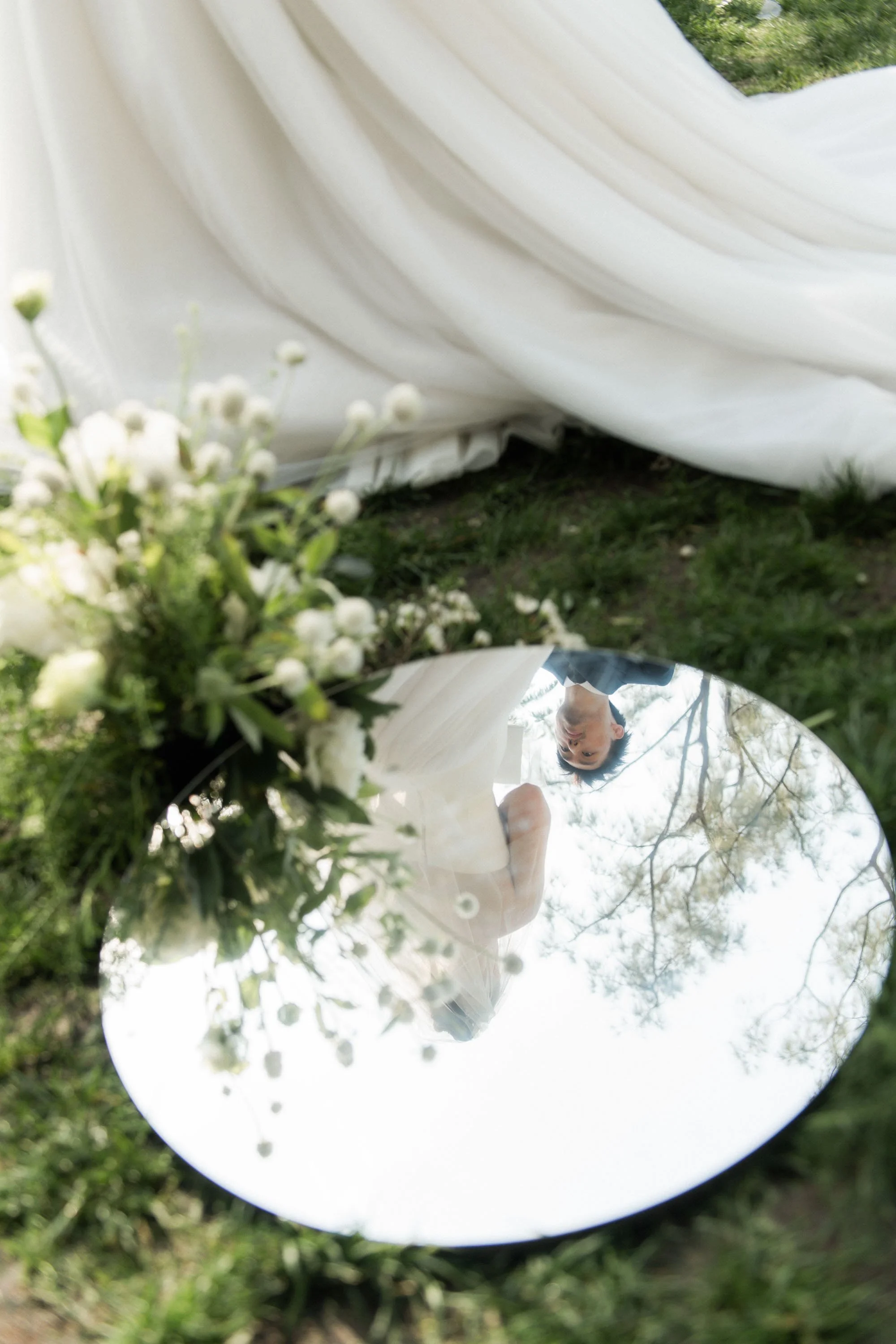Reflection of the bride and groom during the wedding vows.