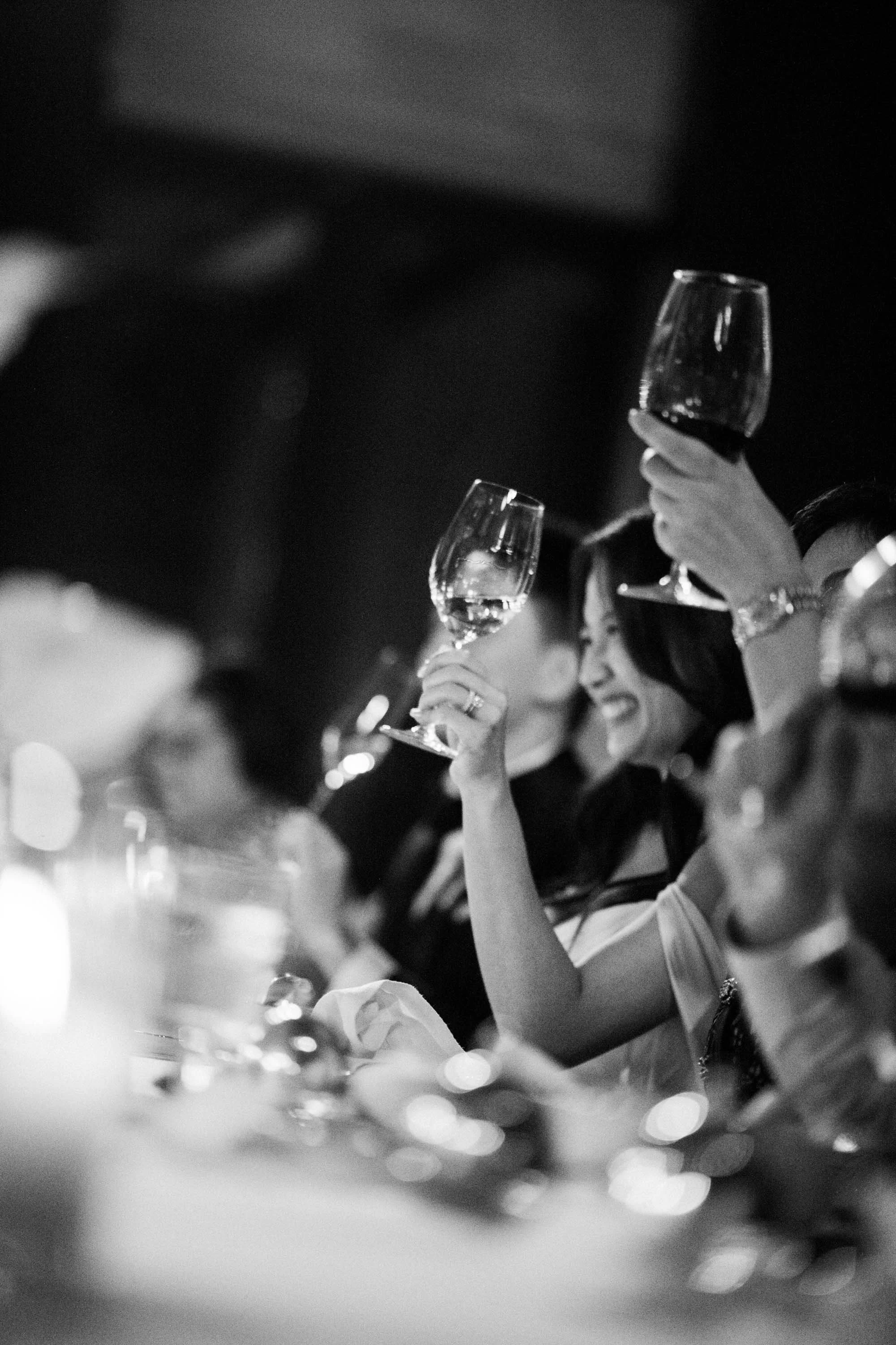 Bride and groom raising a toast with their guests during the reception.