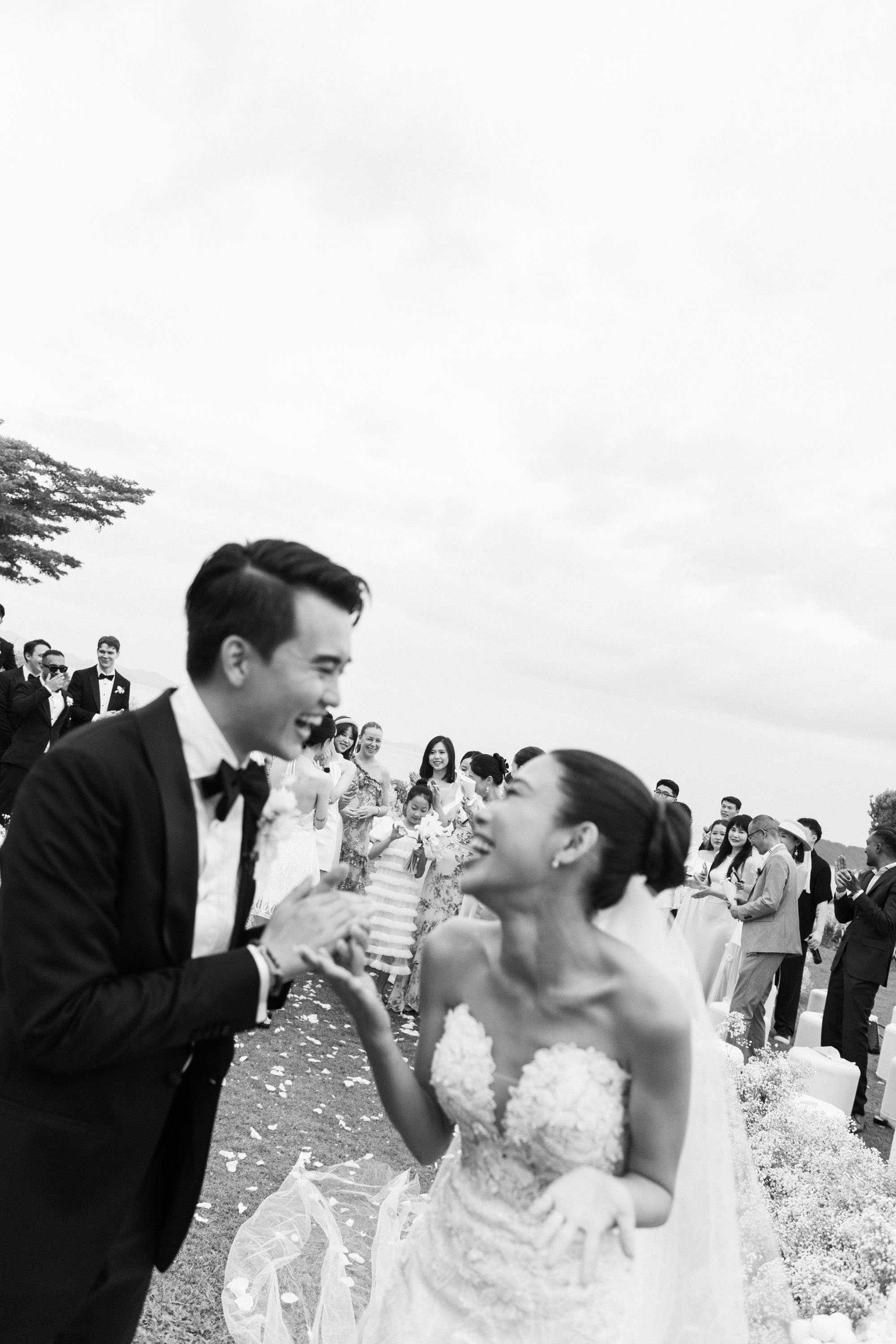 Bride and groom reacting after the bouquet toss.